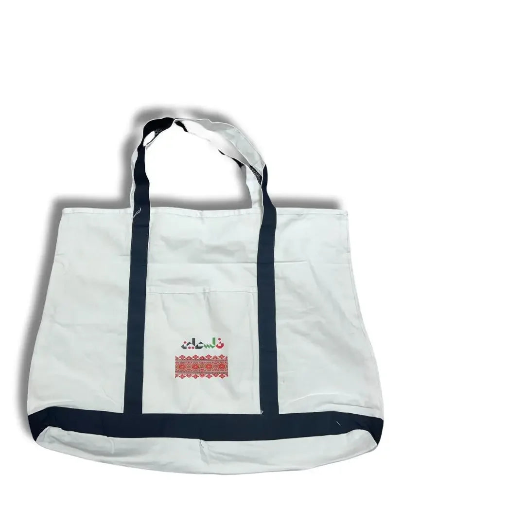 White Palestinian embroidery tote with black handles and traditional red stitched design by Palestinian Elegance