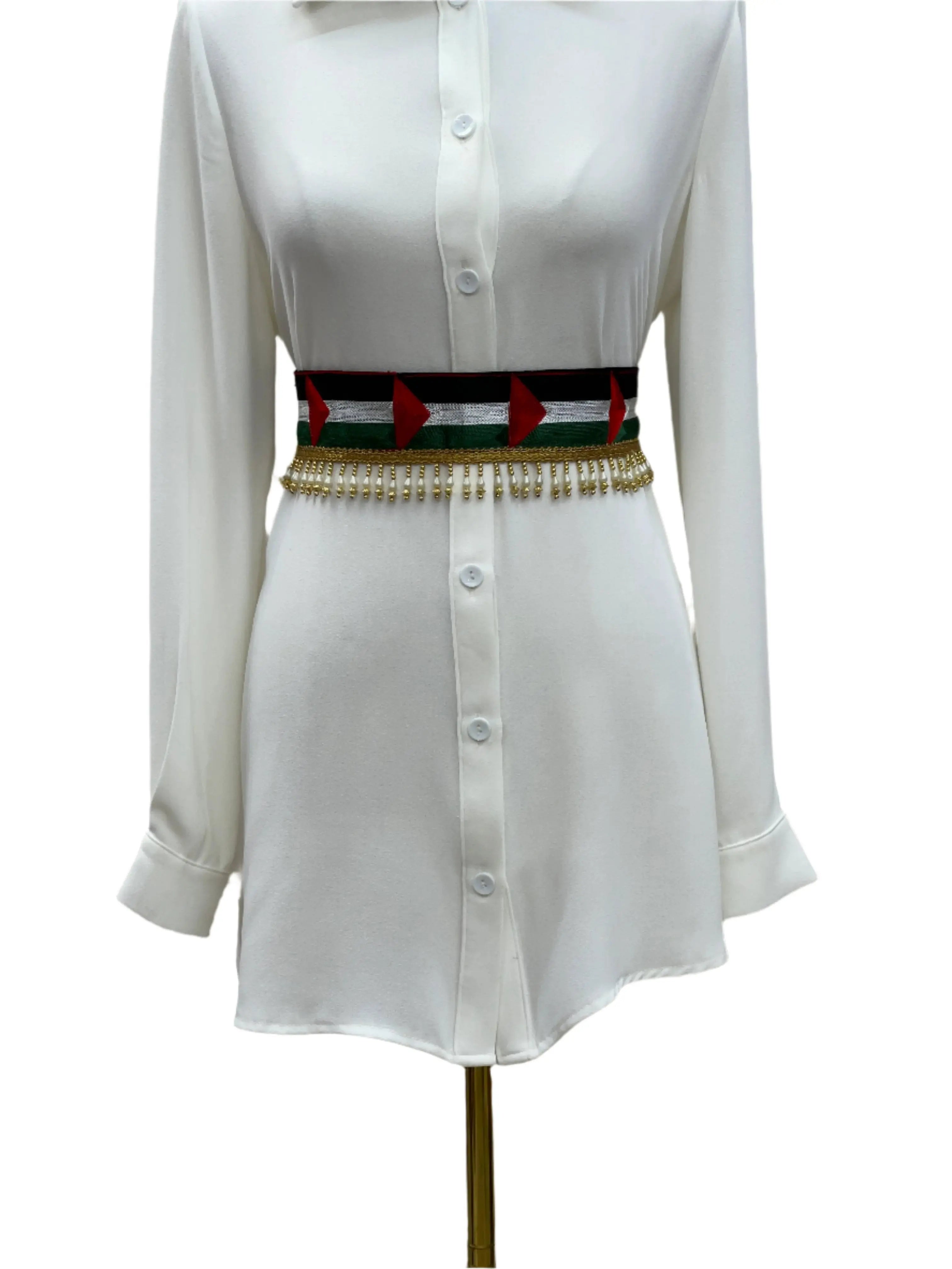 Palestinian flags belt with decorative tassels worn over a white button-down dress by PalestinianElegance