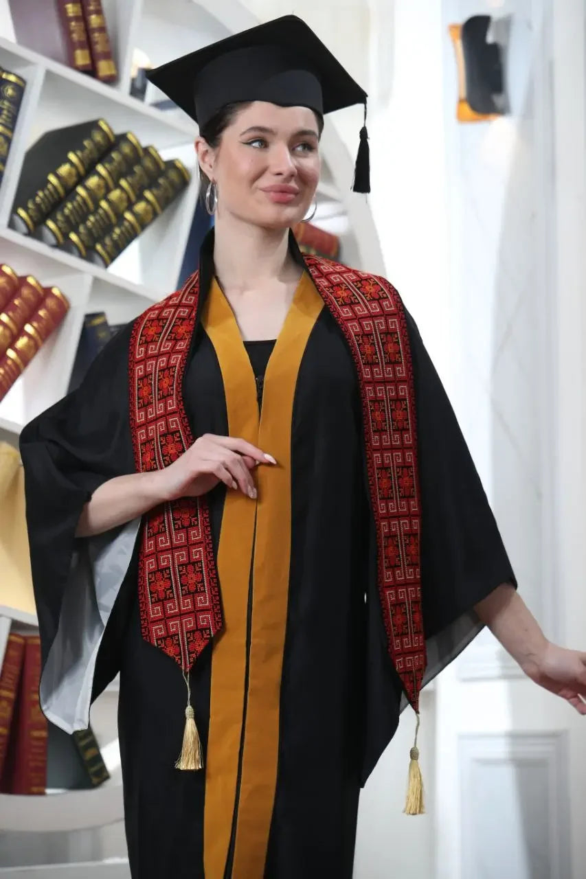 Woman wearing black graduation gown and cap with red and black Palestinian graduation stole by Palestinian Elegance