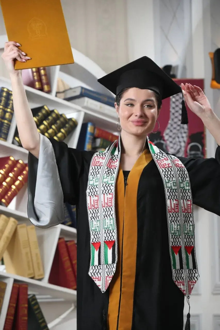 Graduate wearing a Palestinian graduation stole and cap holding a diploma celebrating achievement