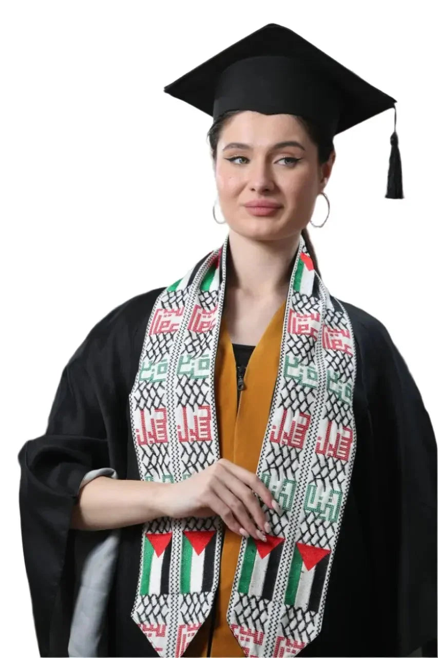 Woman wearing a Palestinian graduation stole with traditional embroidery and colors over graduation gown