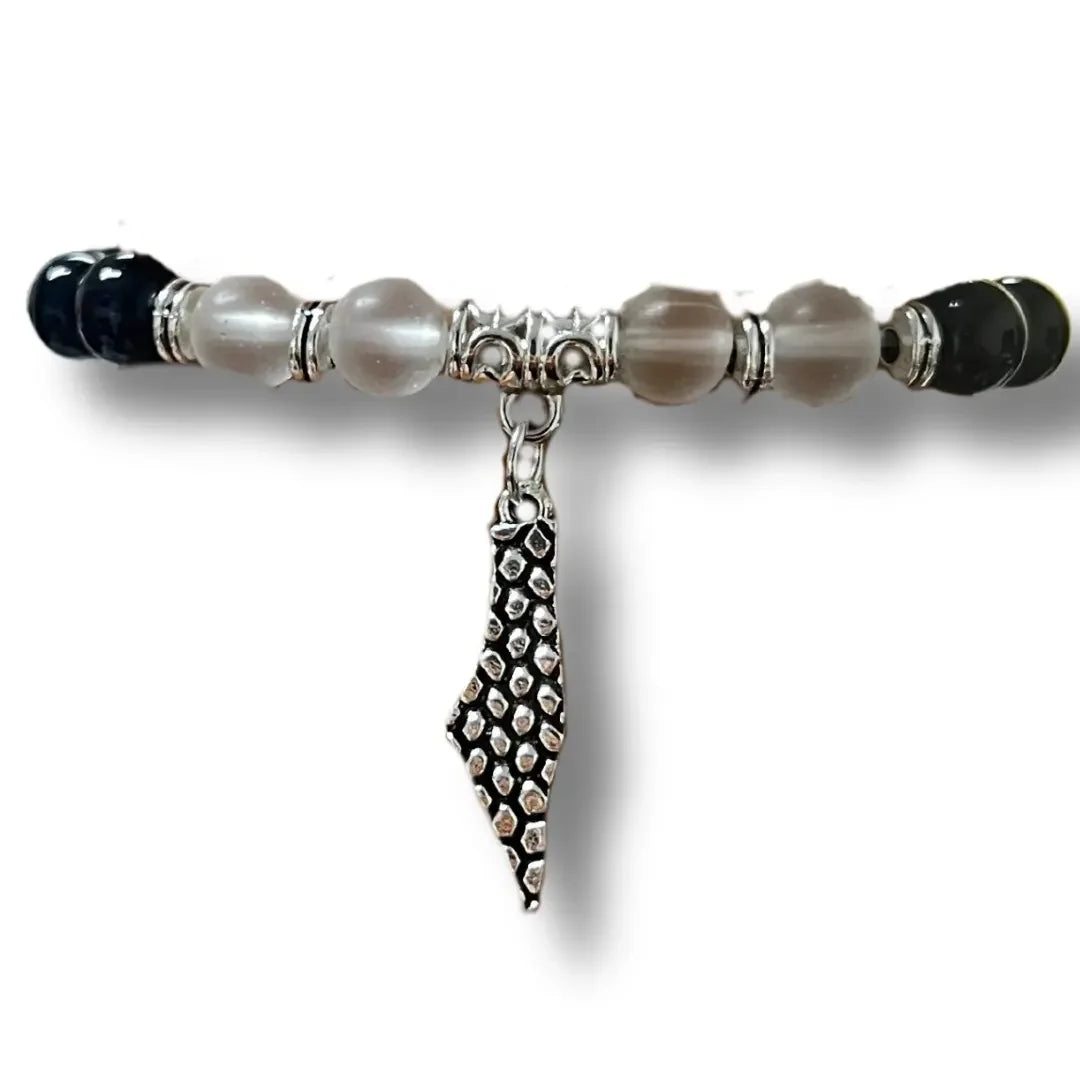 Palestinian silver bracelet with black and gray beads featuring detailed silver charm pendant
