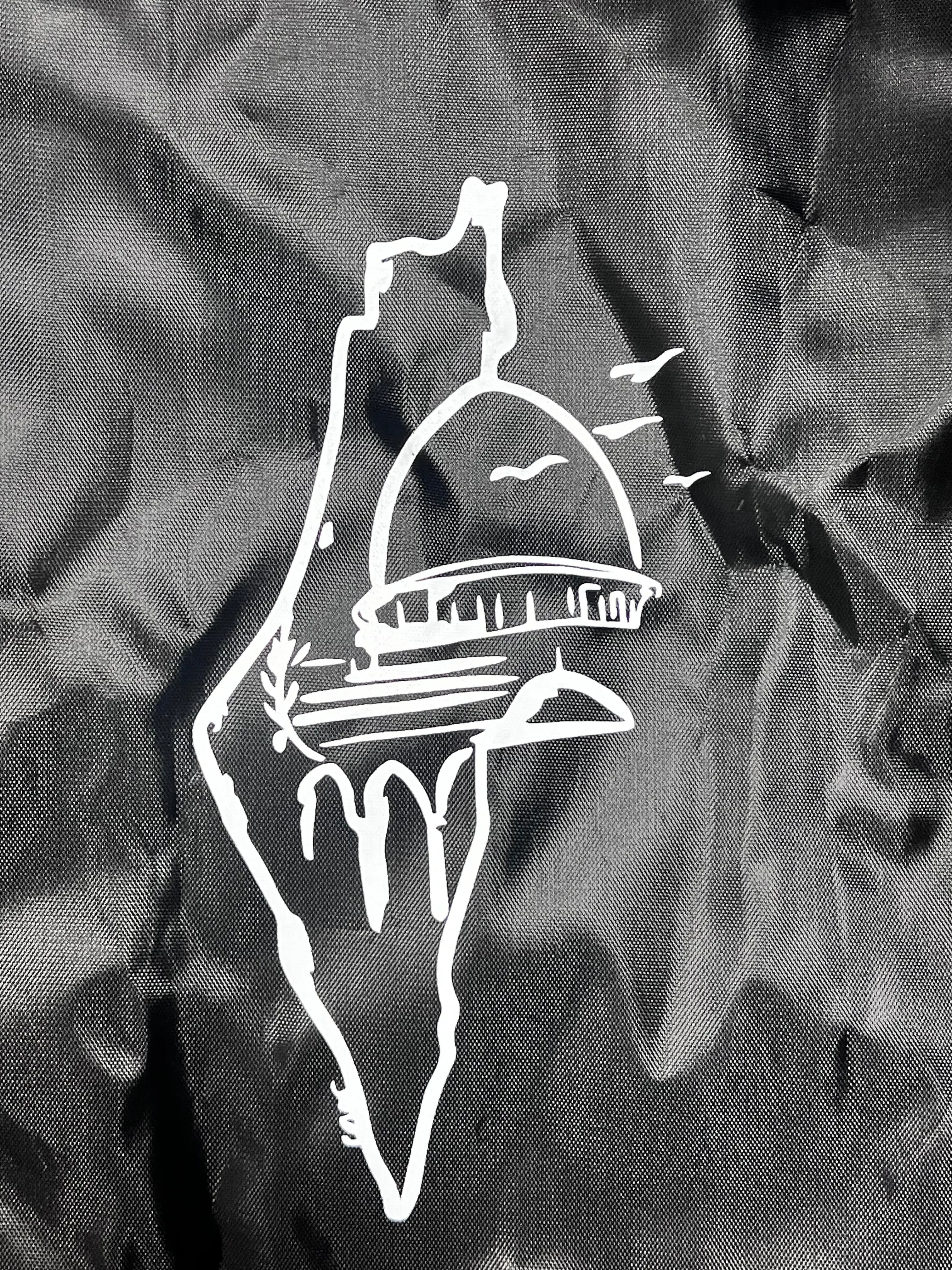 Black Palestinian strap bag with white outline design of Dome of the Rock and birds