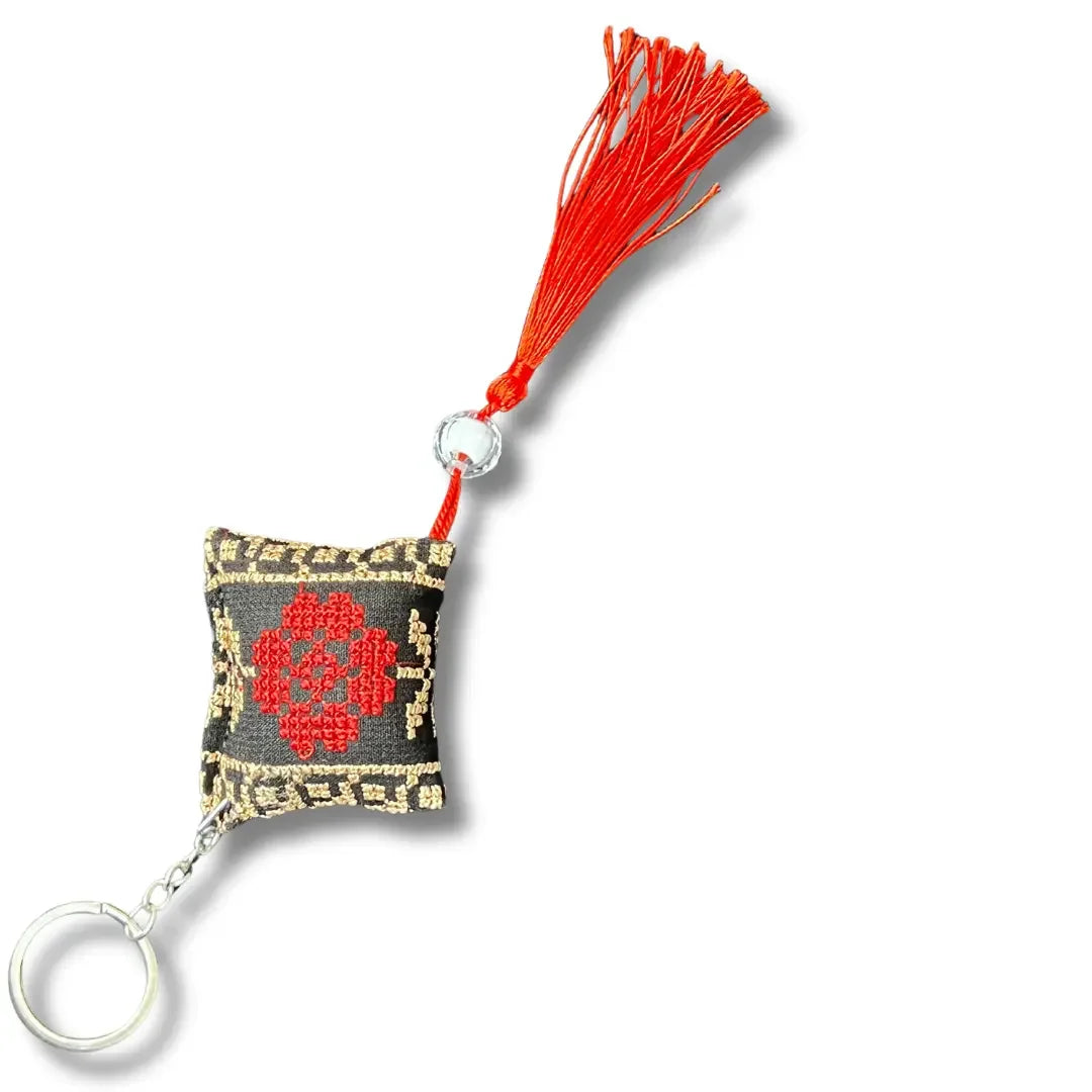 Palestinian Elegance embroidered accessory with red tassel and Palestinian tatreez keychains detail