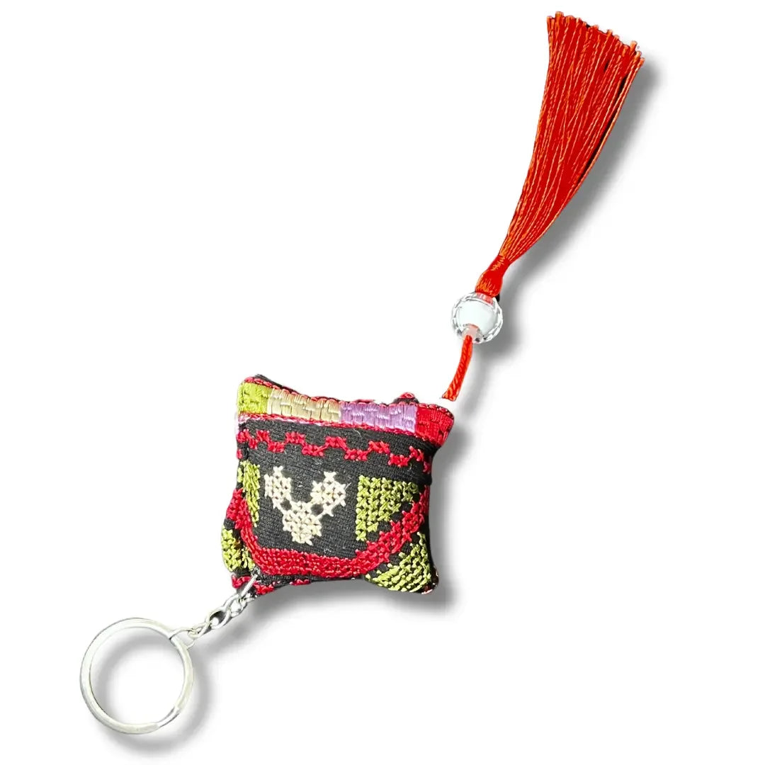 Palestinian tatreez keychains with colorful embroidered design and red tassel accessory