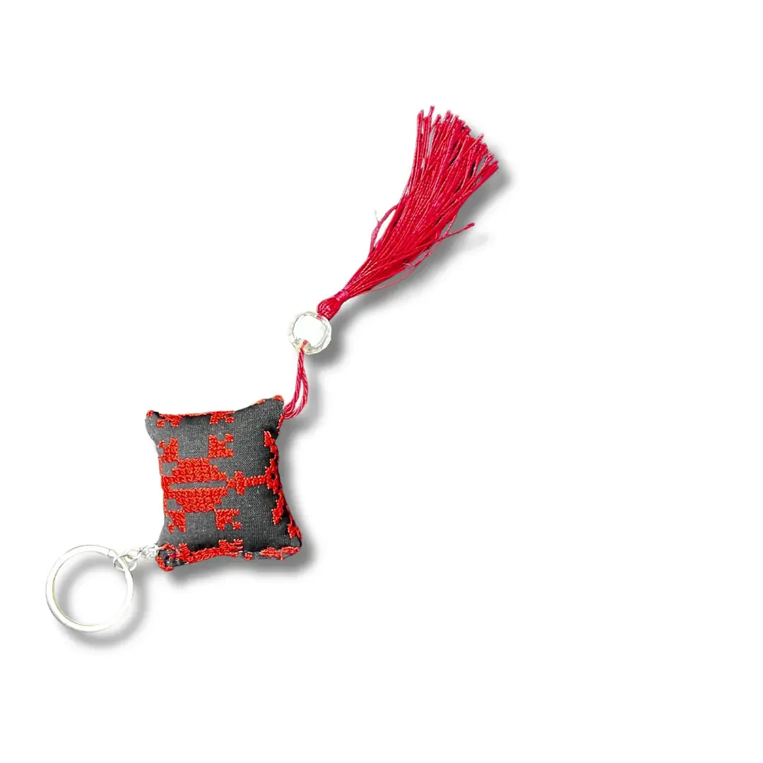 Palestinian tatreez keychains featuring red embroidered design with tassel and metal ring