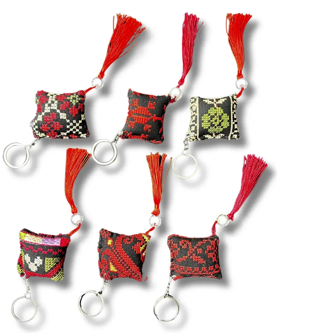 Palestinian tatreez keychains with colorful embroidered designs and red tassels by Palestinian Elegance