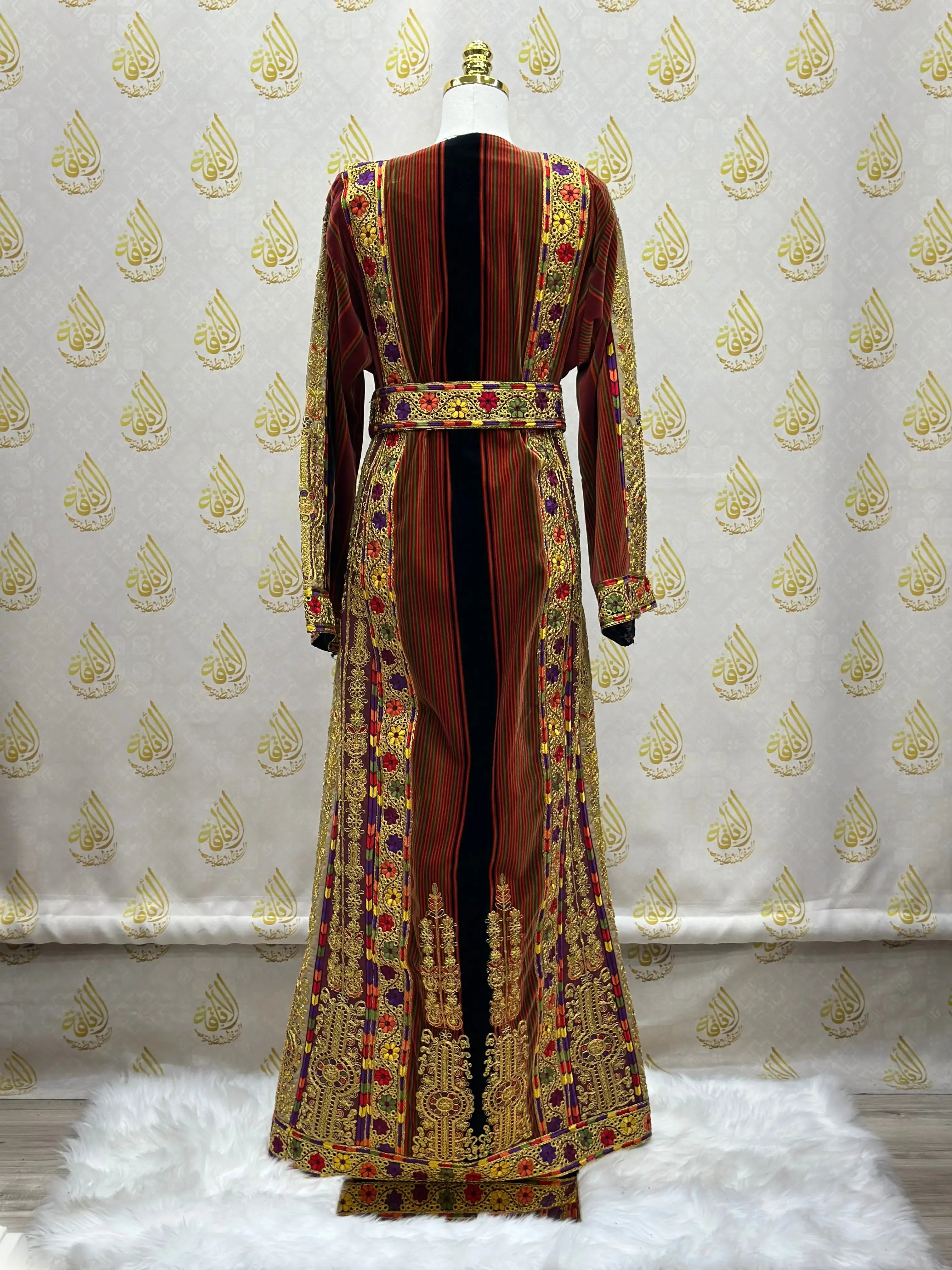Back view of Palestinian thoub dress with intricate embroidery in red, gold, and black by Palestinian Elegance