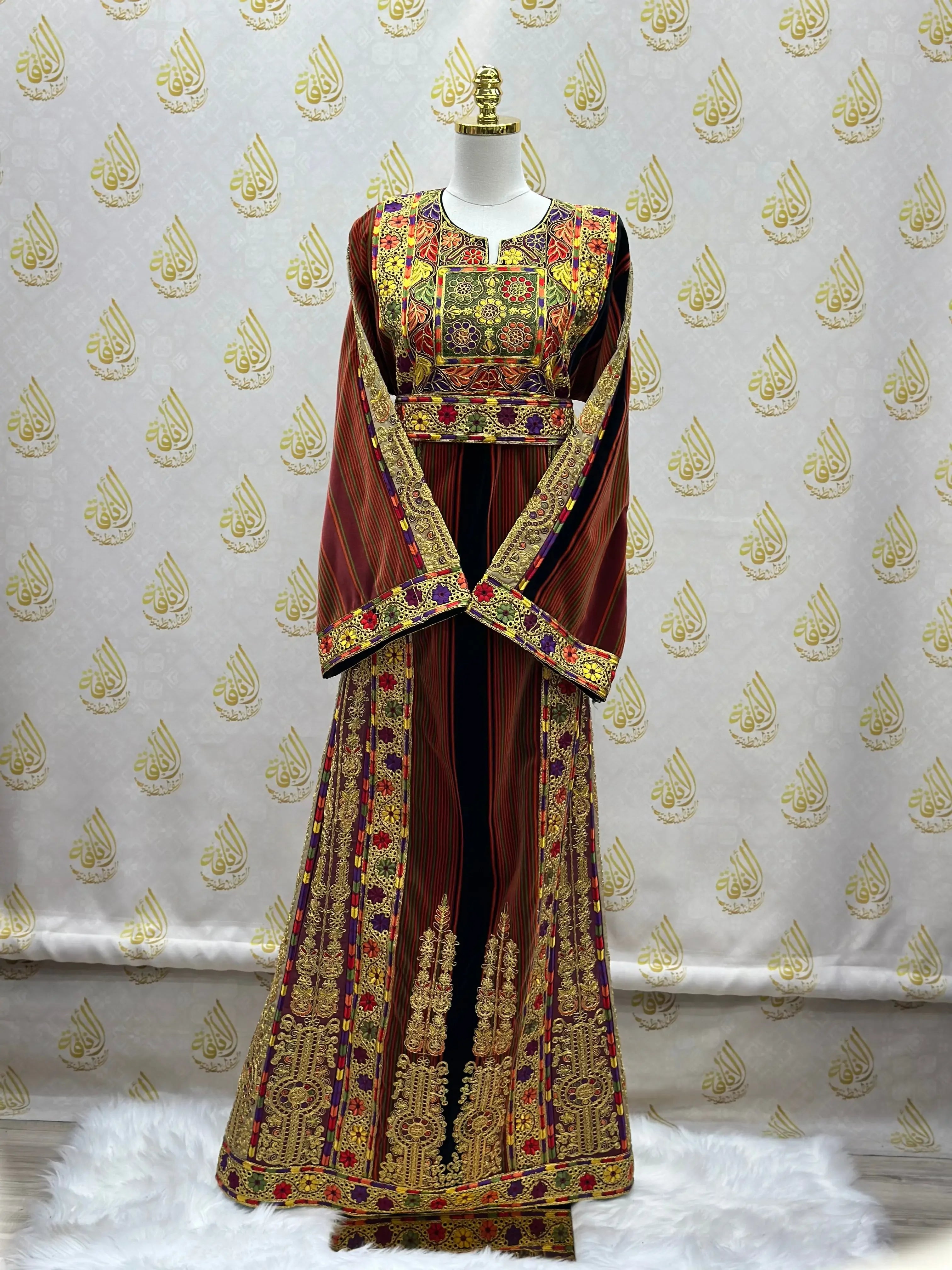 Palestinian thoub dress with intricate traditional embroidery in rich red and gold tones by Palestinian Elegance