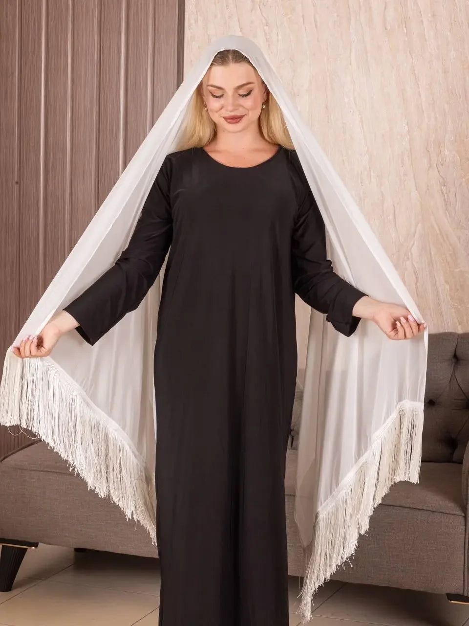 Woman wearing traditional Palestinian khirka white shawl with fringe from Palestinian Elegance