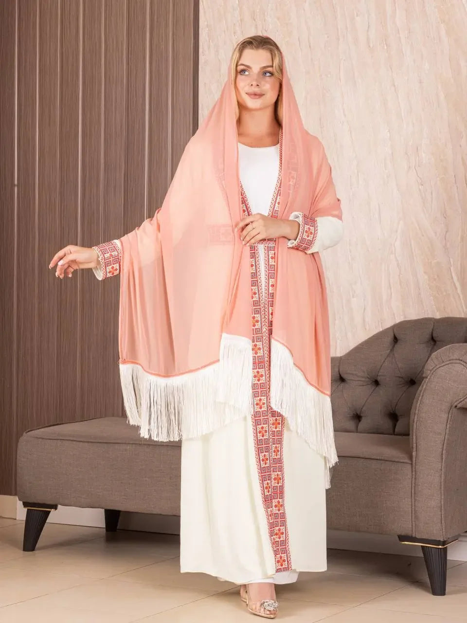 Traditional Palestinian khirka shawl in soft peach with intricate embroidery and white fringe detail
