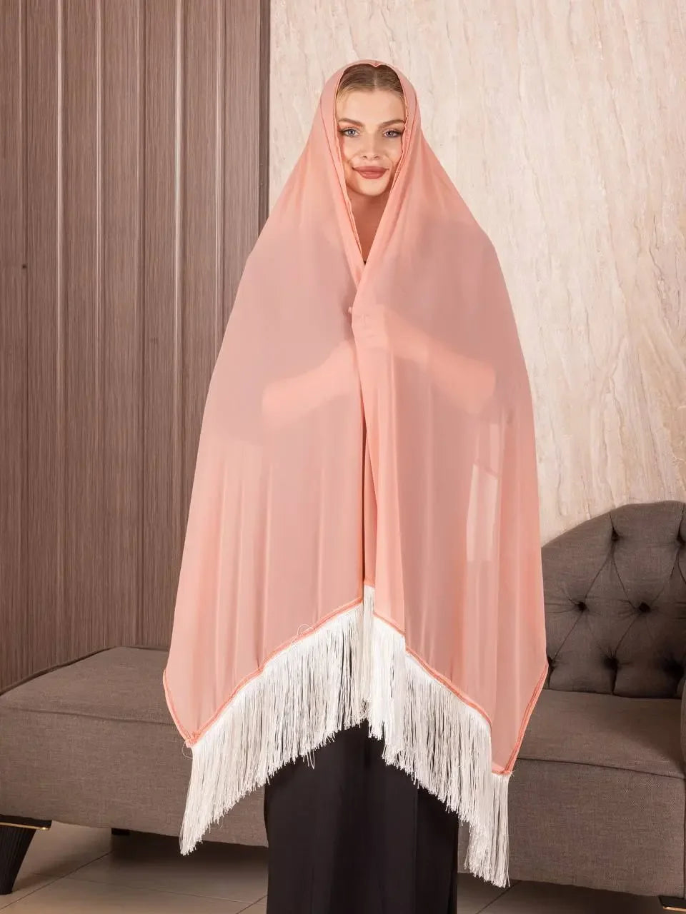 Palestinian Elegance traditional Palestinian khirka shawl in soft peach with white fringe worn by woman