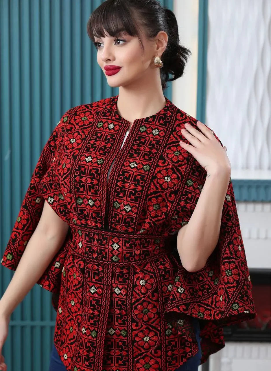 Palestinian embroidered cape in red and black with intricate traditional patterns worn as a casual stylish top