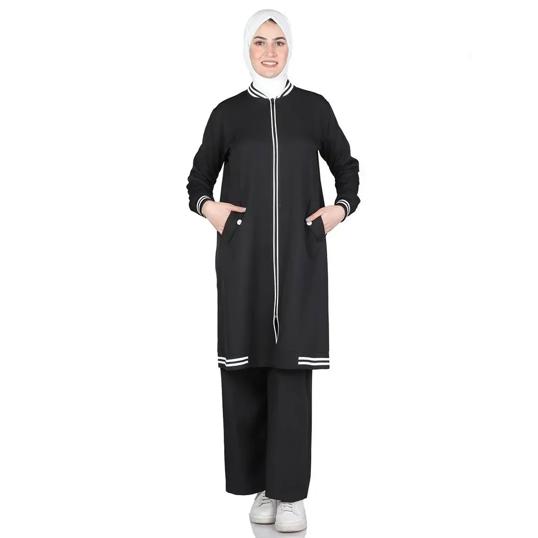 Modest light tracking suit from Palestinian Elegance featuring black long jacket and pants with white trim