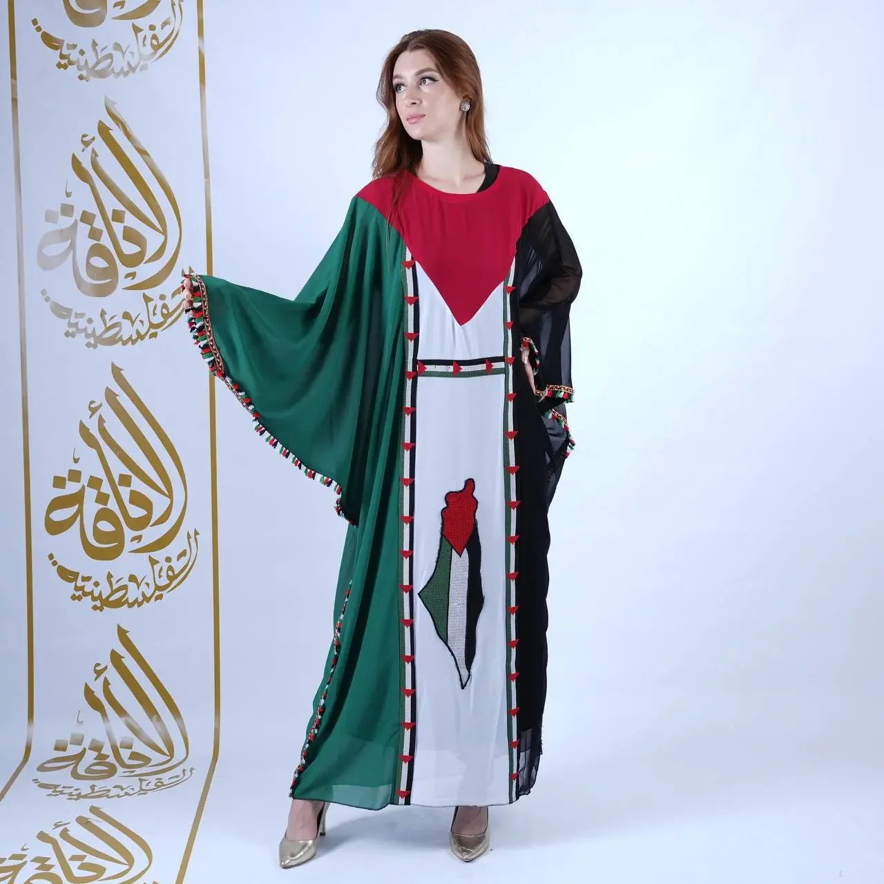 Woman wearing a casual Palestinian flag dress with red, green, black, and white colors from Palestinian Elegance