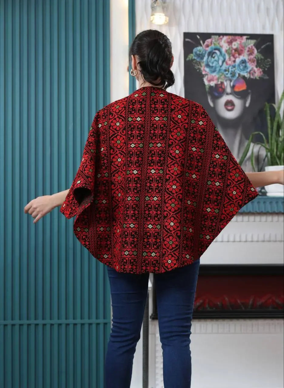 Palestinian embroidered cape with traditional red and black embroidery worn casually by a woman from Palestinian Elegance