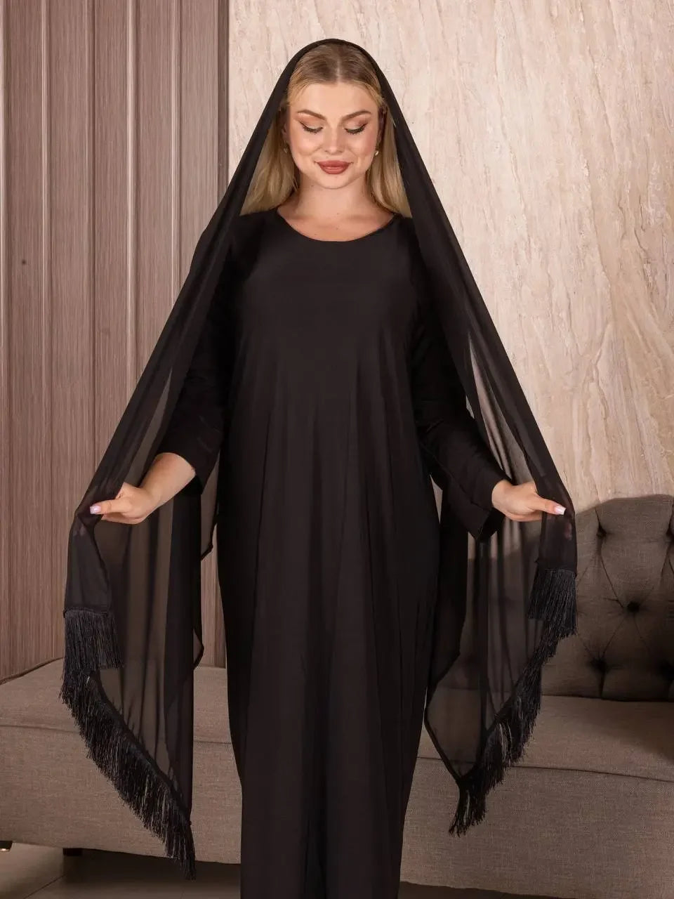 Woman wearing a black shawl from Palestinian Elegance styled as a traditional Palestinian khirka