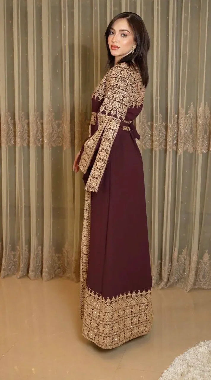 Palestinian Elegance tatreez dress for women featuring traditional embroidery on maroon fabric with intricate gold patterns