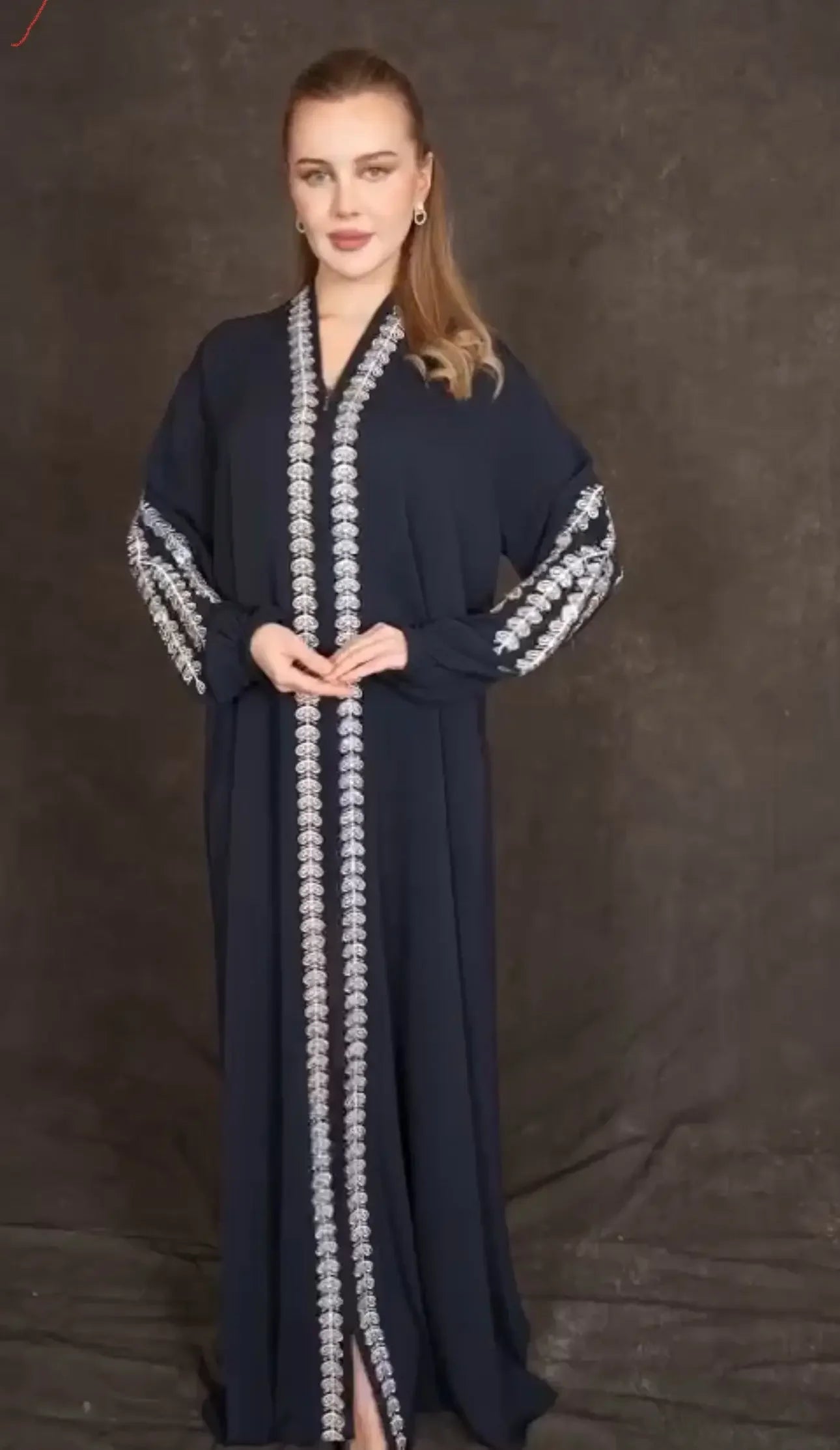 Plus size embroidered abaya by Palestinian Elegance in black with decorative white embroidery on sleeves and front