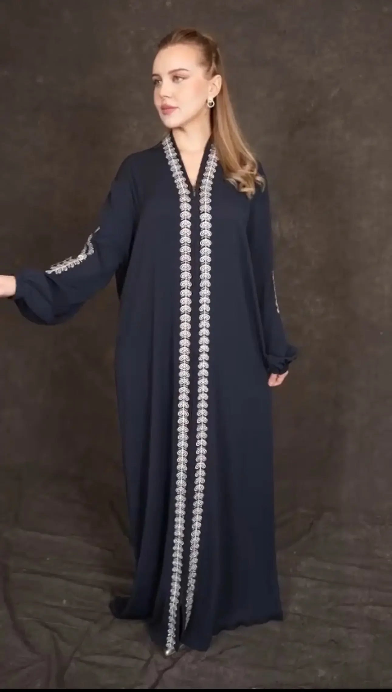 Plus size embroidered abaya by Palestinian Elegance in navy with intricate white embroidery along front and sleeves