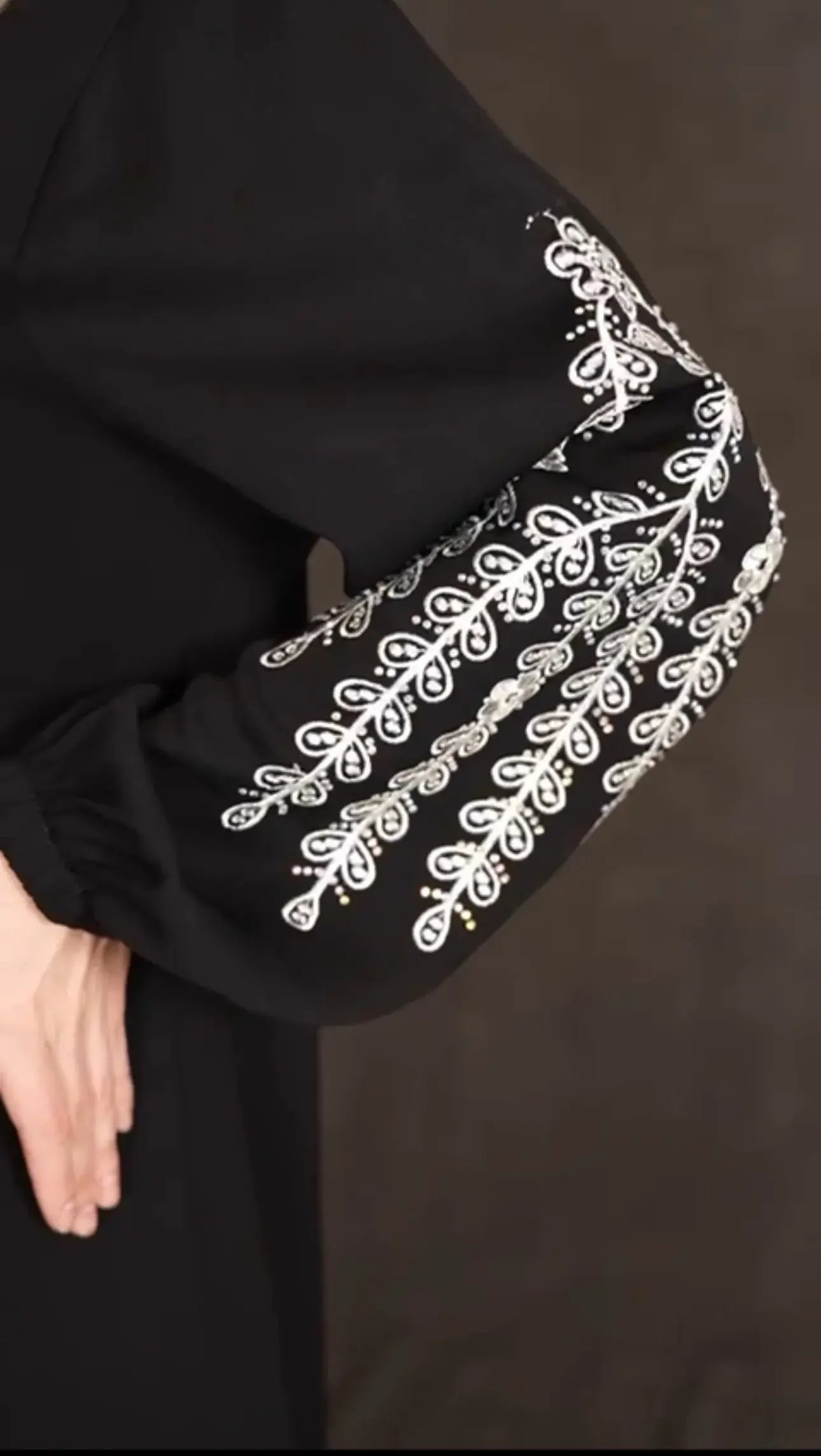 Plus size embroidered abaya sleeve with detailed white floral embroidery on black fabric by Palestinian Elegance