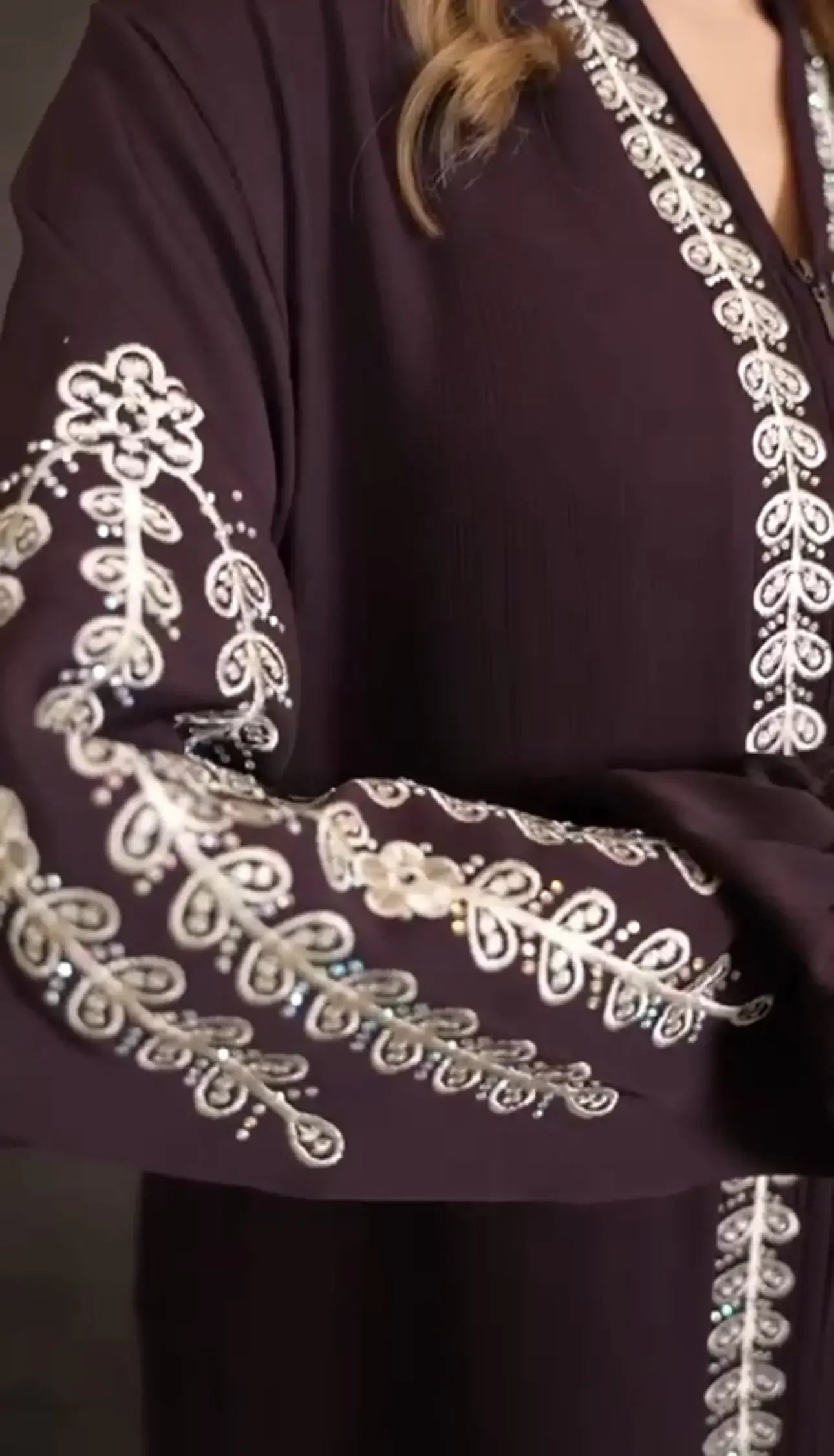 Plus size embroidered abaya by Palestinian Elegance with intricate white embroidery on dark fabric
