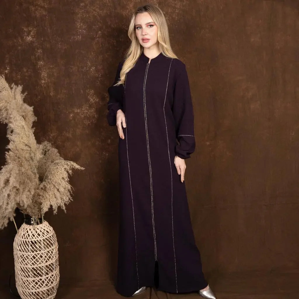 Plus size embroidered abaya by Palestinian Elegance in dark color with long sleeves and intricate stitching