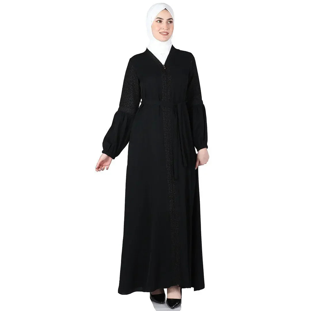 Palestinian Elegance black puff sleeve abaya with front detailing and belt worn with white hijab