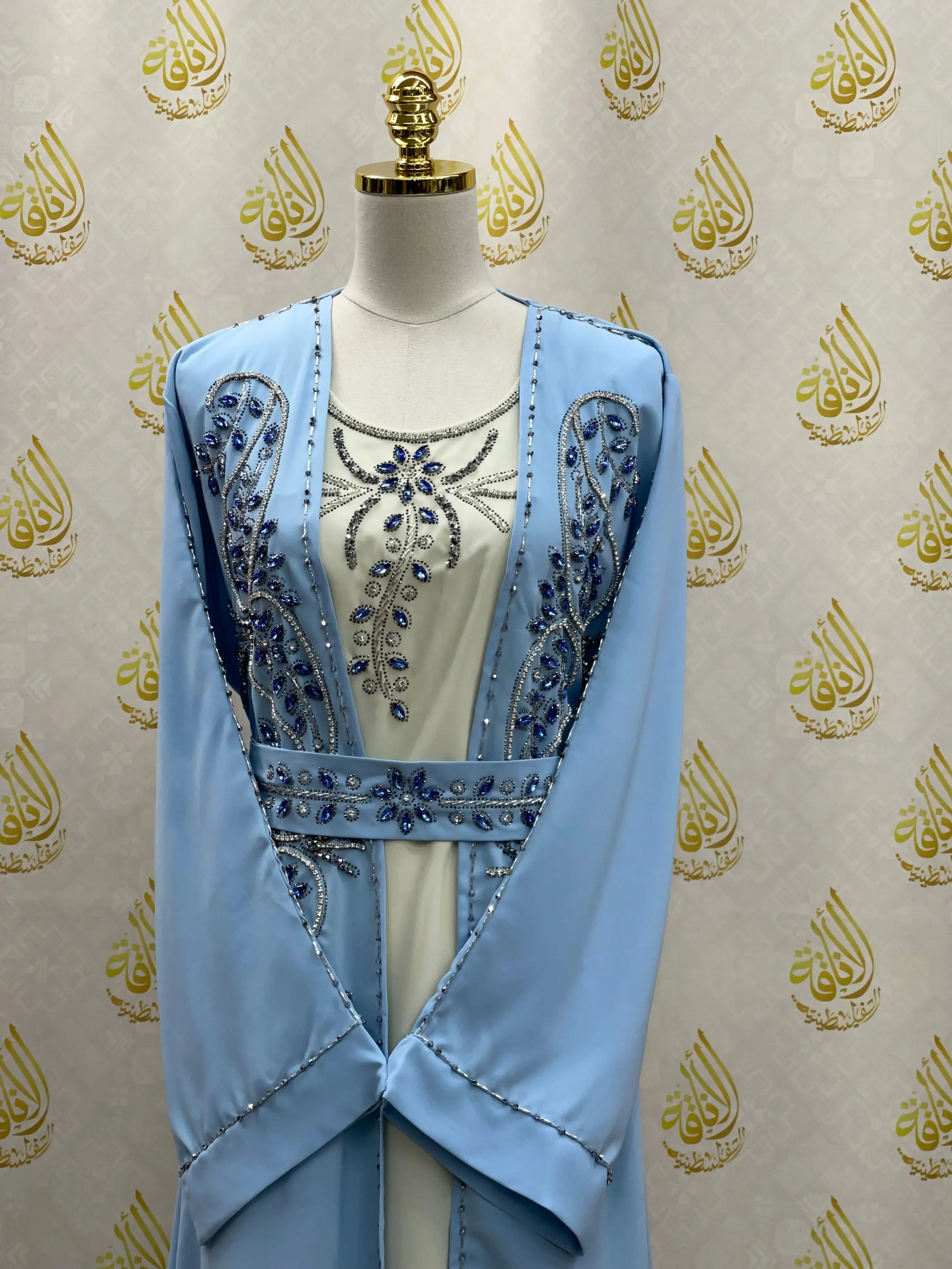 Light blue rhinestone moroccan abaya with intricate beadwork and floral designs on mannequin