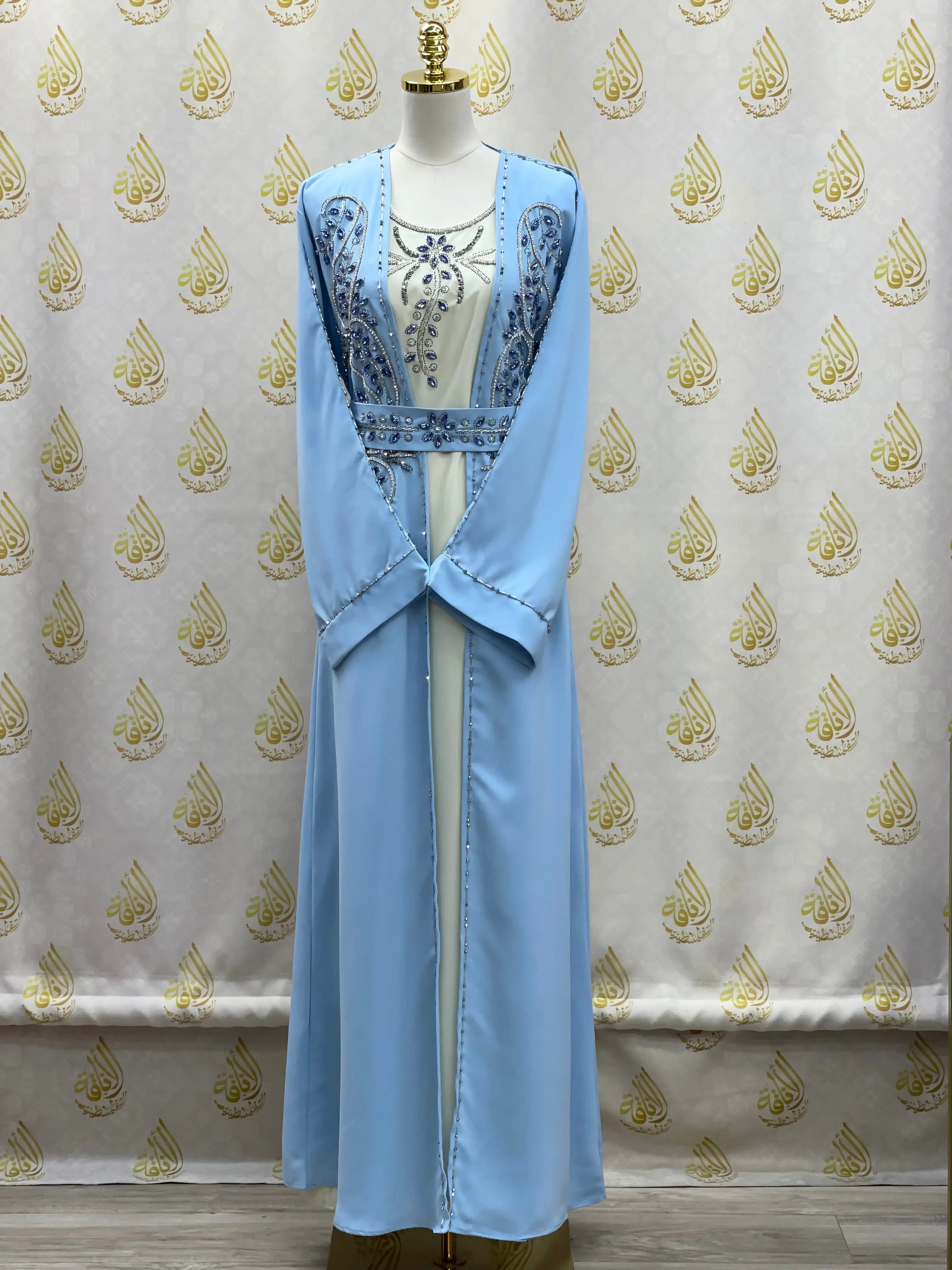 Light blue rhinestone moroccan abaya by Palestinian Elegance featuring intricate embellishments on front and sleeves