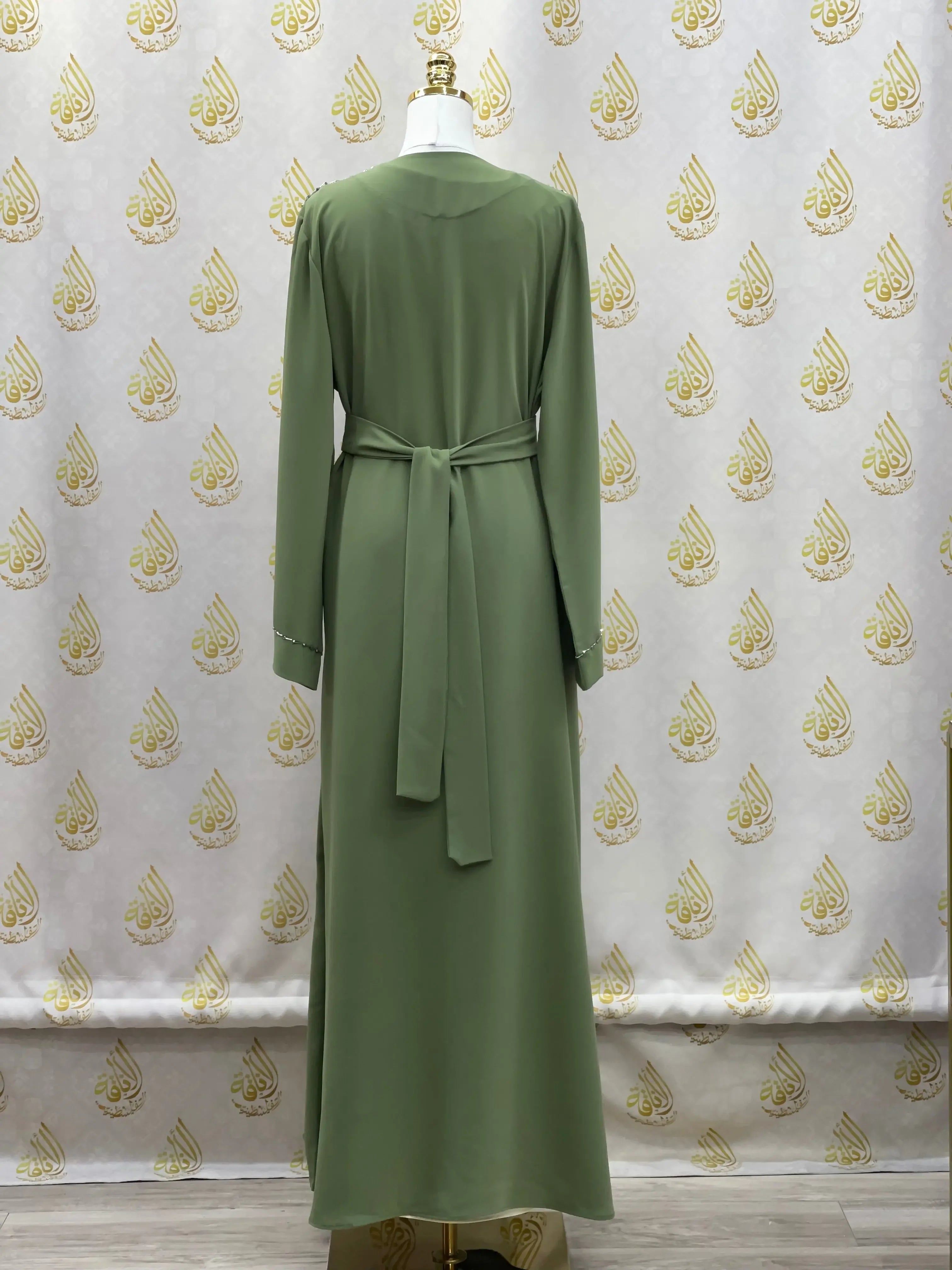 Back view of olive green rhinestone moroccan abaya by Palestinian Elegance with waist tie belt