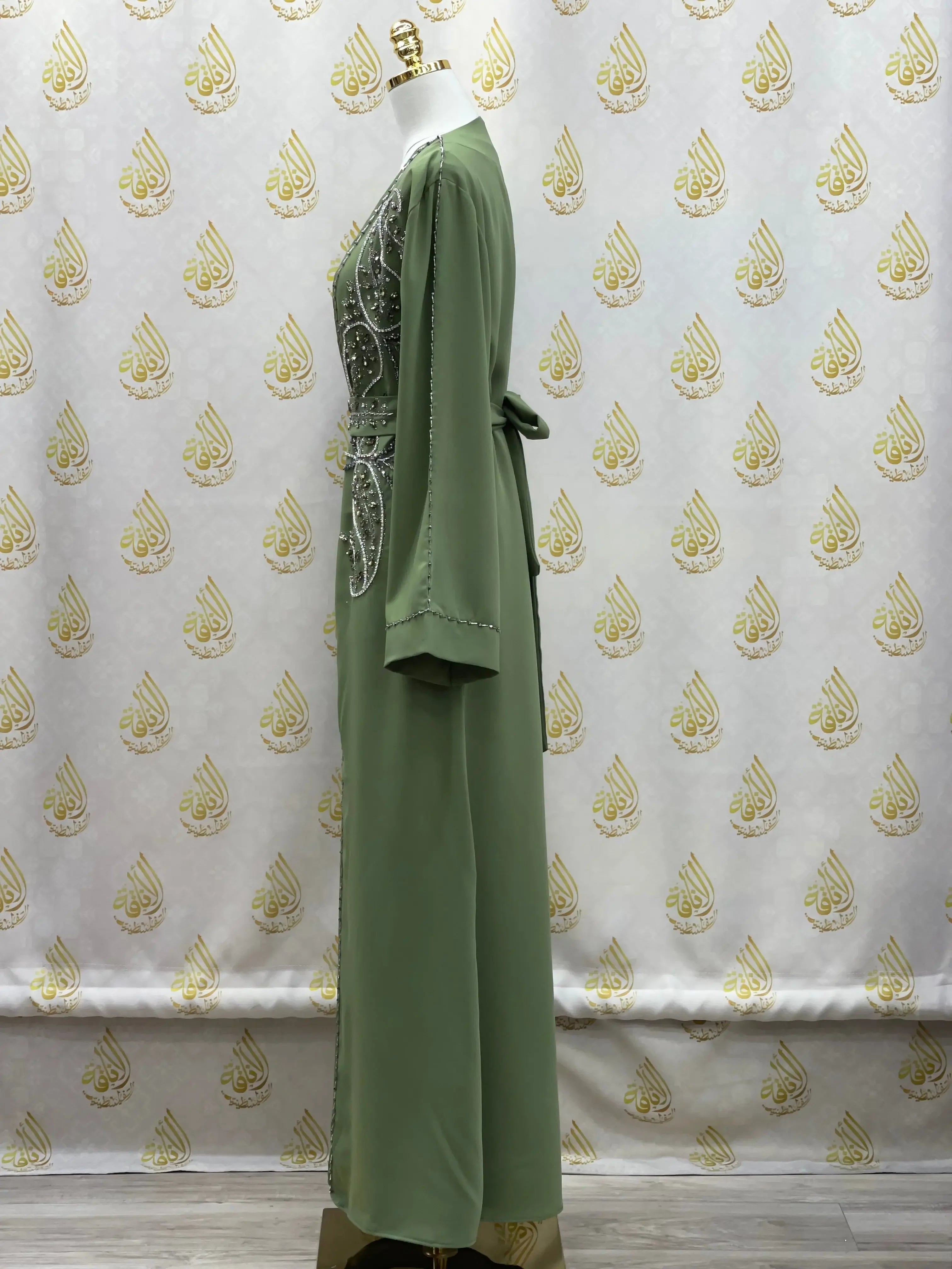Side view of green rhinestone moroccan abaya by Palestinian Elegance with detailed embellishments