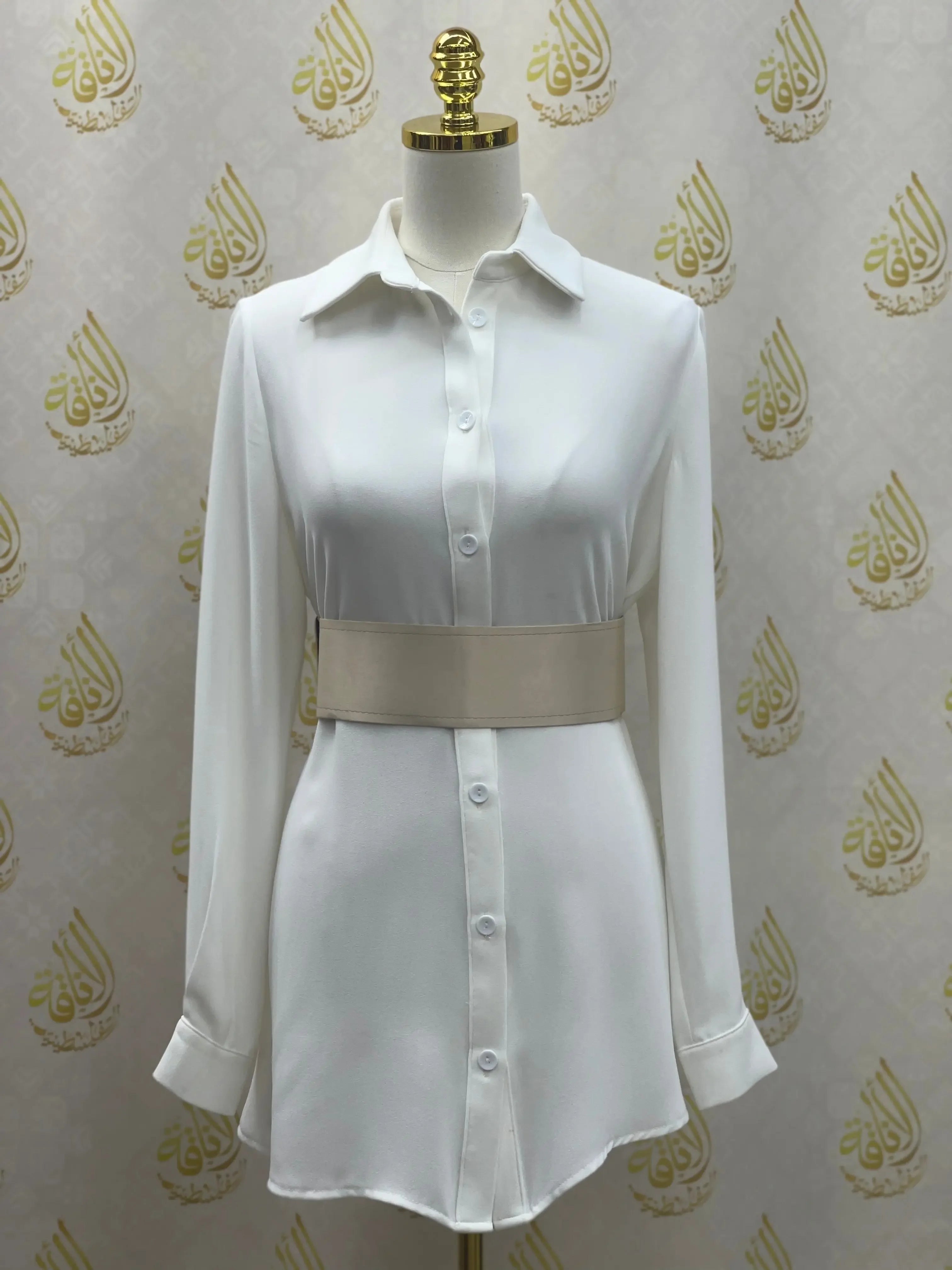 Satin waist belt in beige styled over a white button-down dress on a mannequin