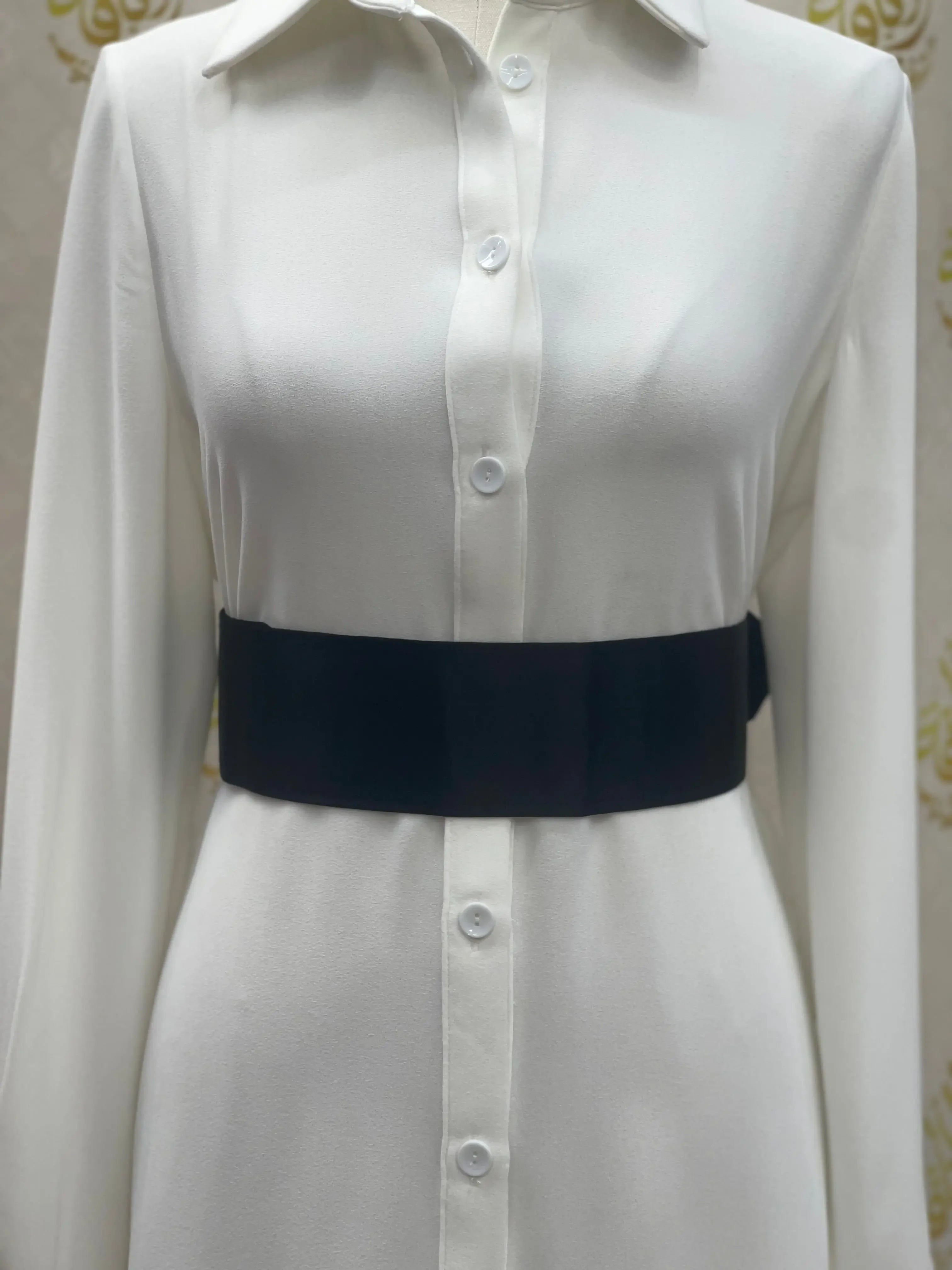 Palestinian Elegance satin waist belt in black worn over white button-down dress shirt