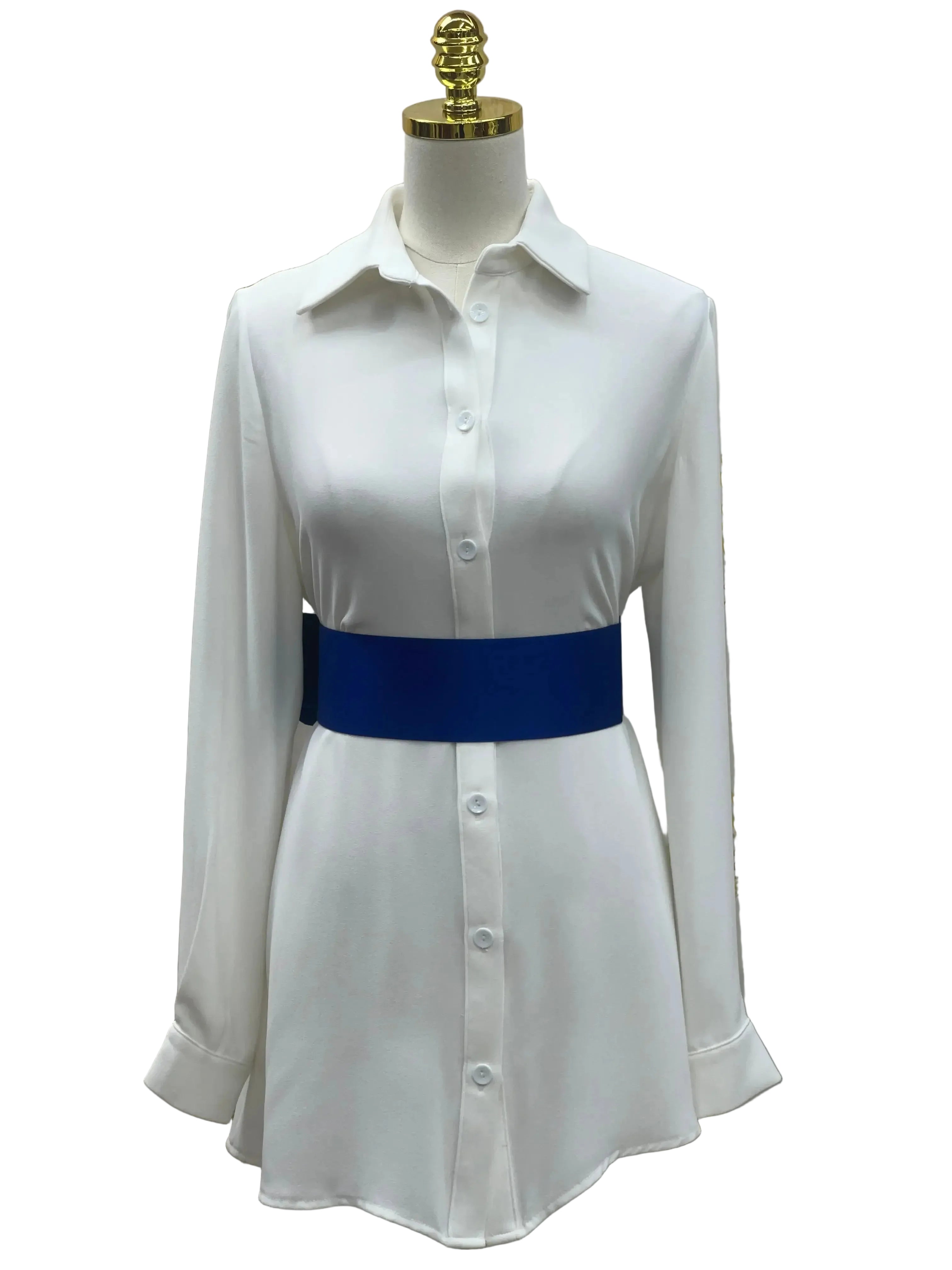 White button-down dress styled with a blue satin waist belt by Palestinian Elegance