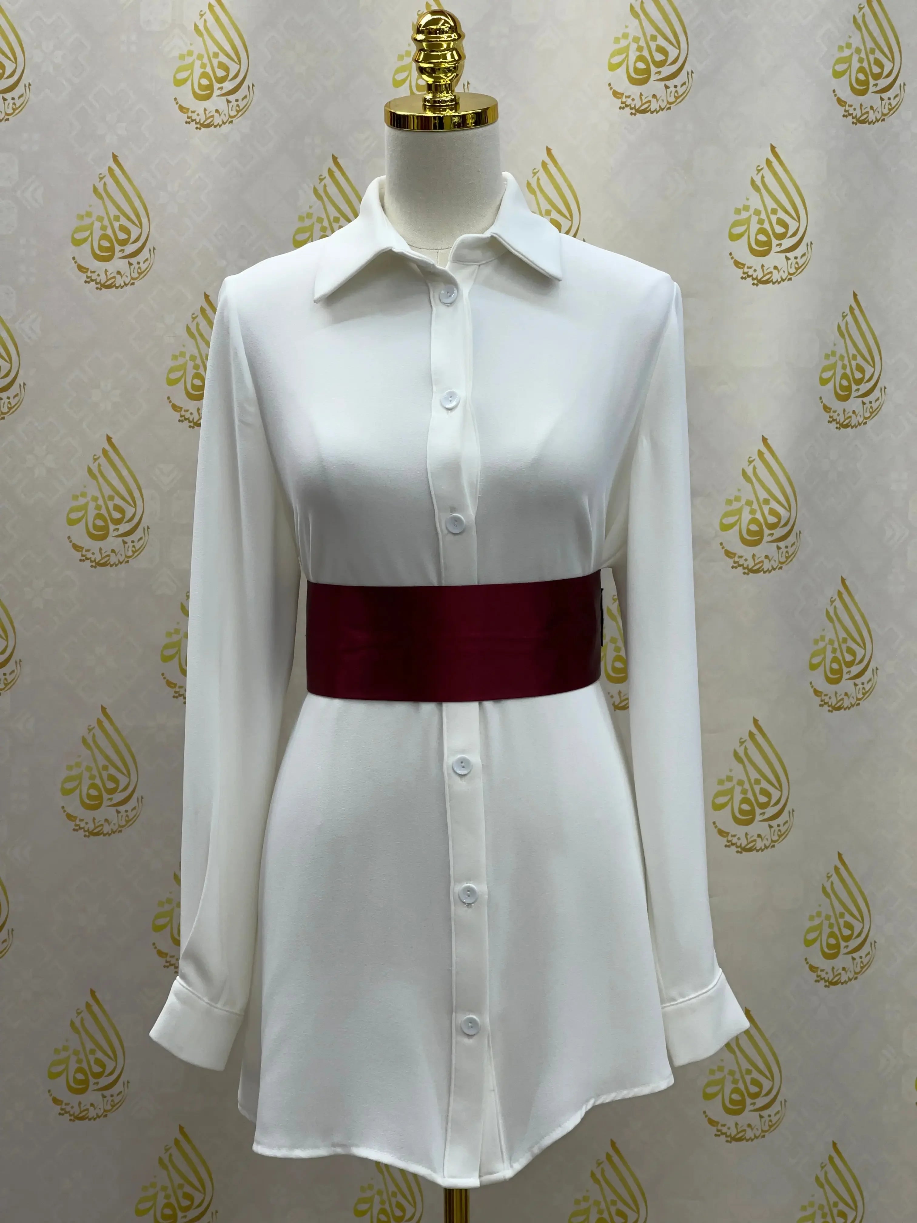Palestinian Elegance satin waist belt in deep red styled on white button-up dress