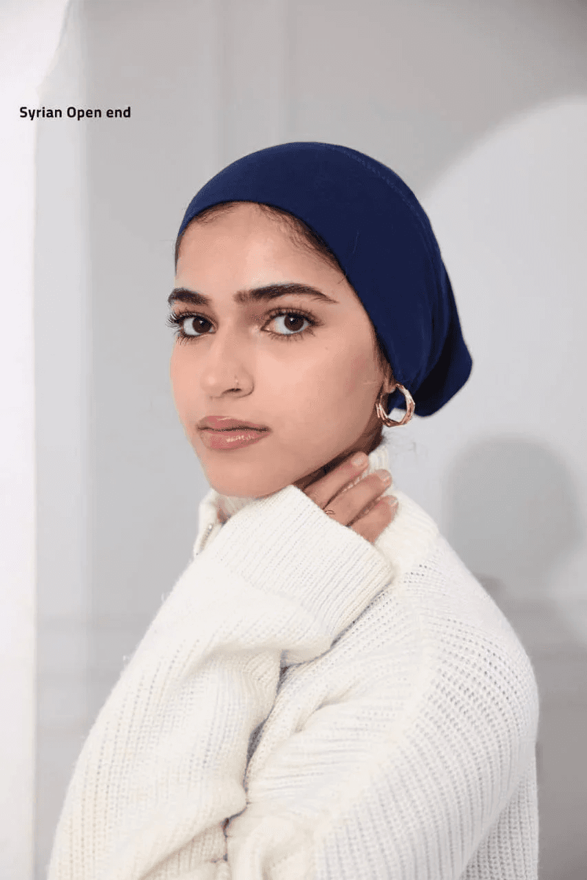 Woman wearing a navy blue Syrian-Style Open Bonnet headwear paired with a white knit sweater