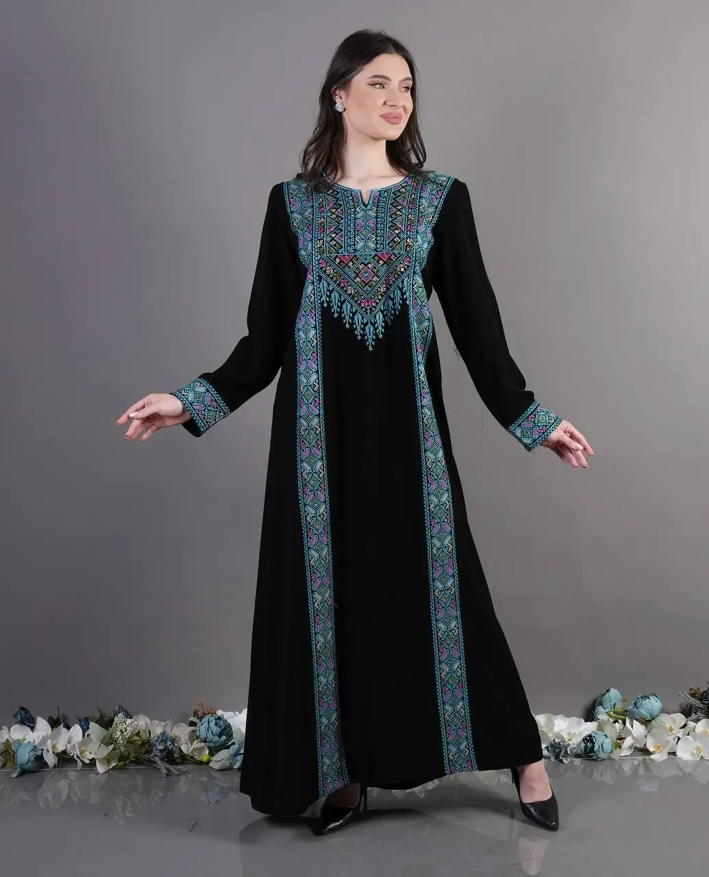 Palestinian Elegance black Tatreez Abaya Dress with colorful embroidered patterns on front and cuffs