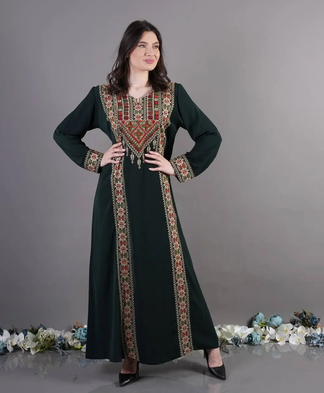 Palestinian Elegance Tatreez Abaya Dress in dark fabric with traditional embroidered patterns and long sleeves