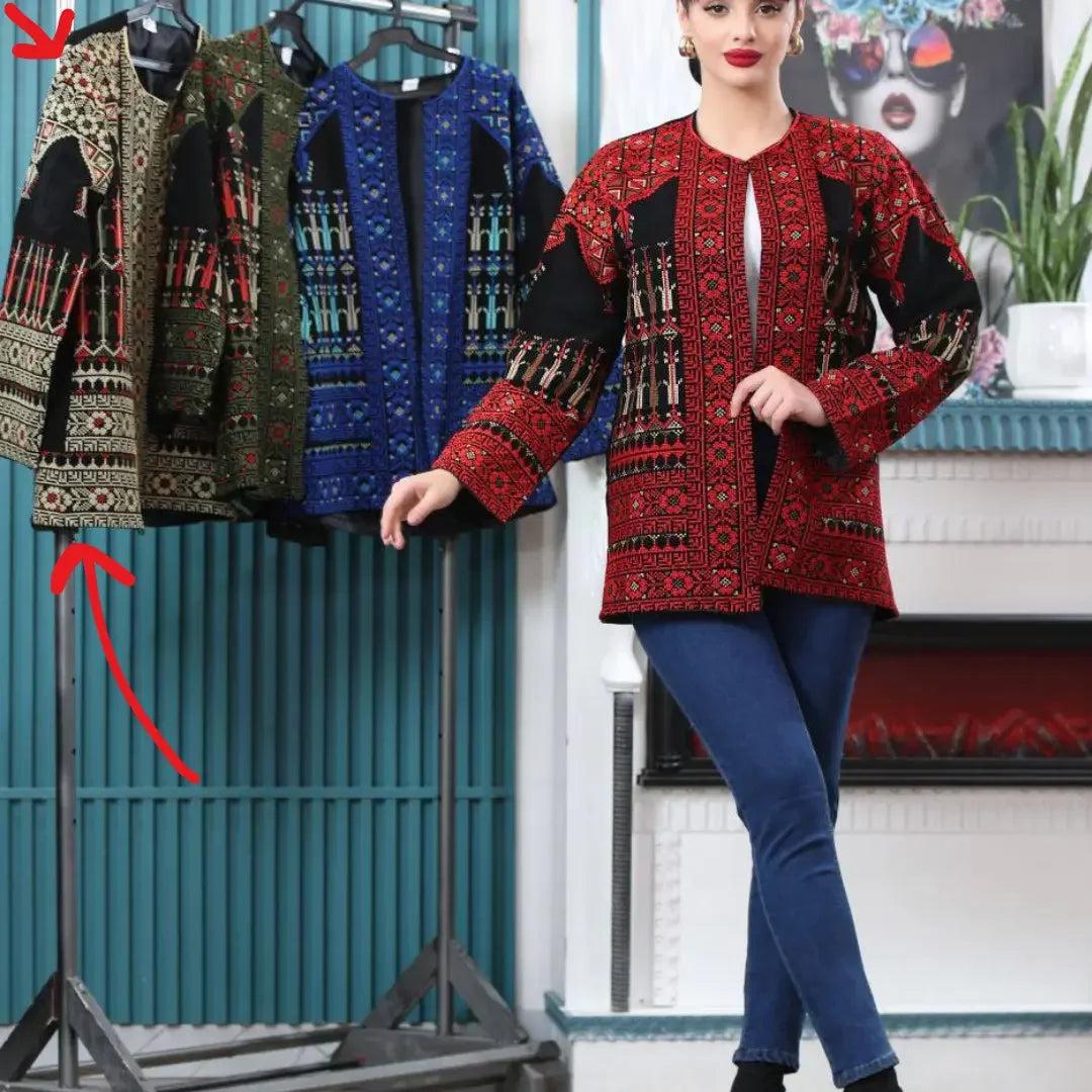 Palestinian Elegance tatreez embroidered jacket in red worn by model with additional jackets in olives and blue on rack
