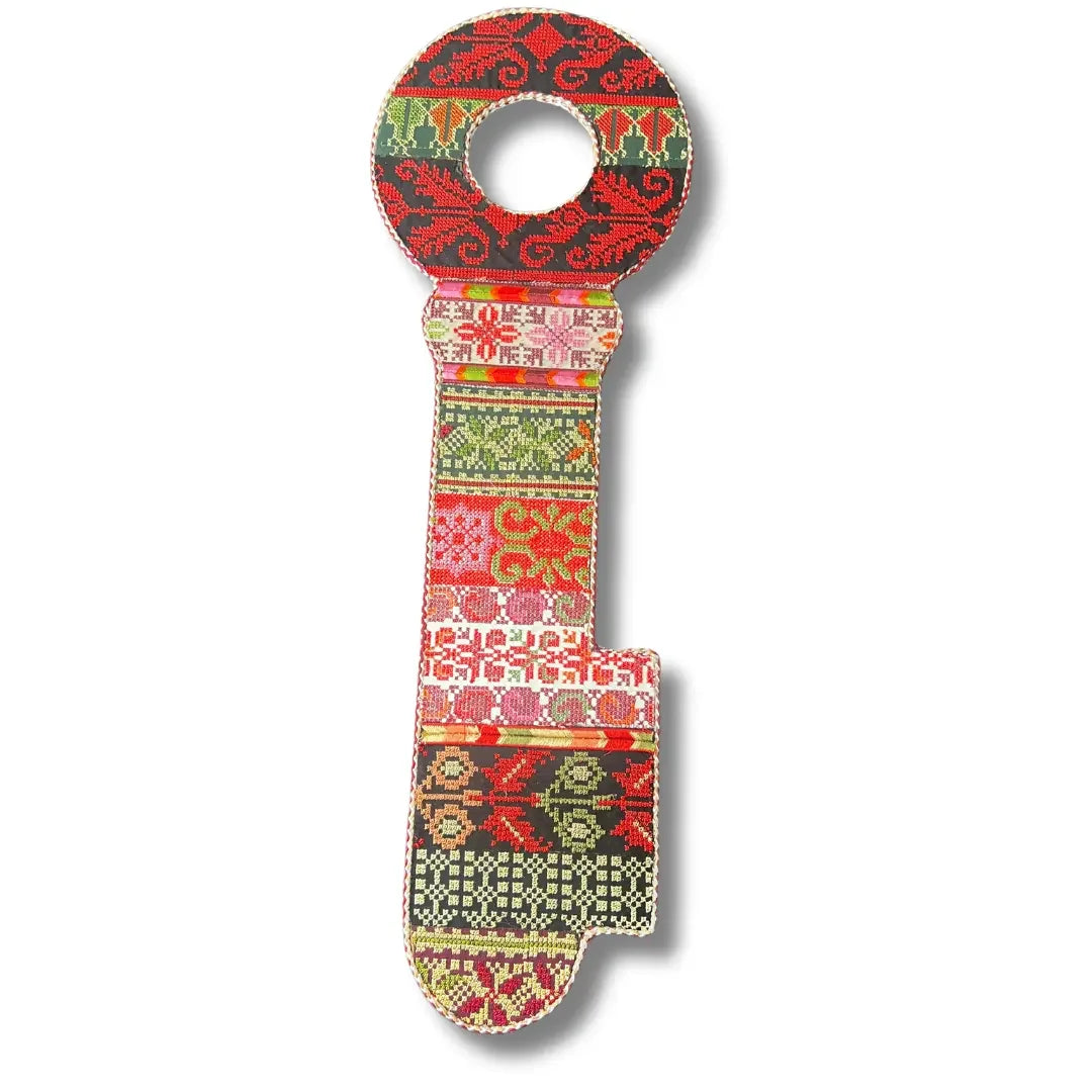 Colorful tatreez key accessory with traditional Palestinian embroidery patterns in red green and pink