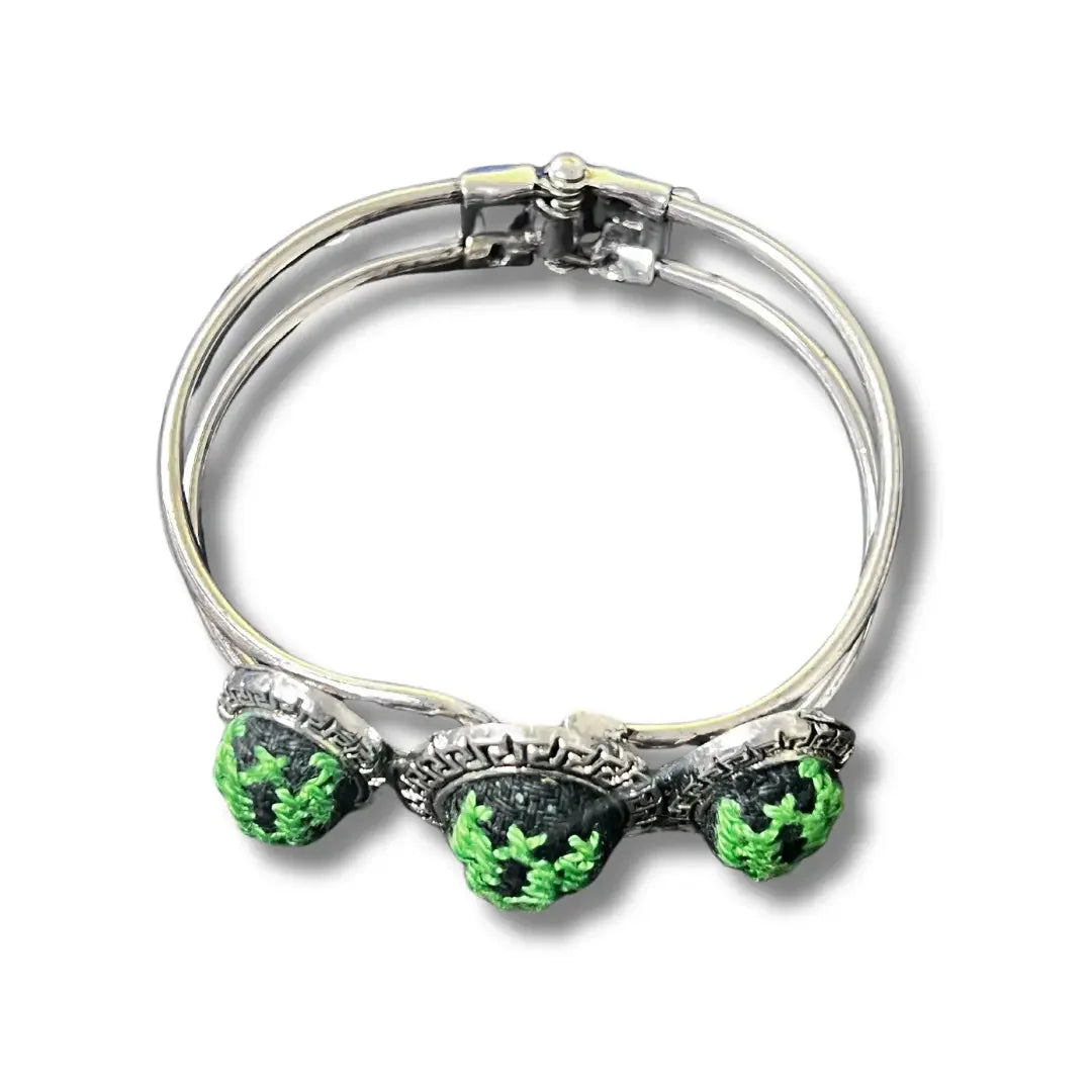 Palestinian Elegance tatreez silver bracelet with green embroidered accents on silver band