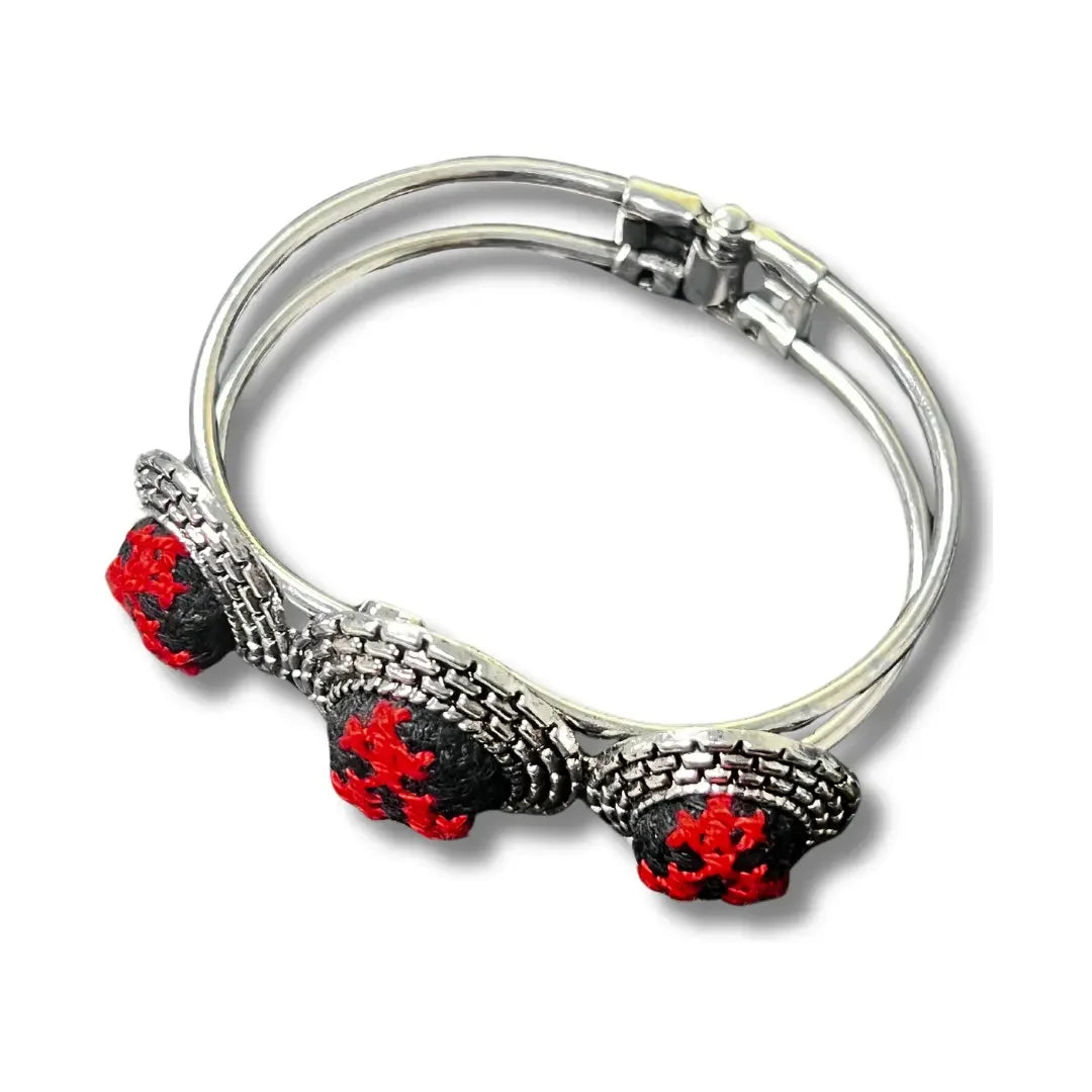 Palestinian Elegance tatreez silver bracelet with intricate red and black embroidery accents