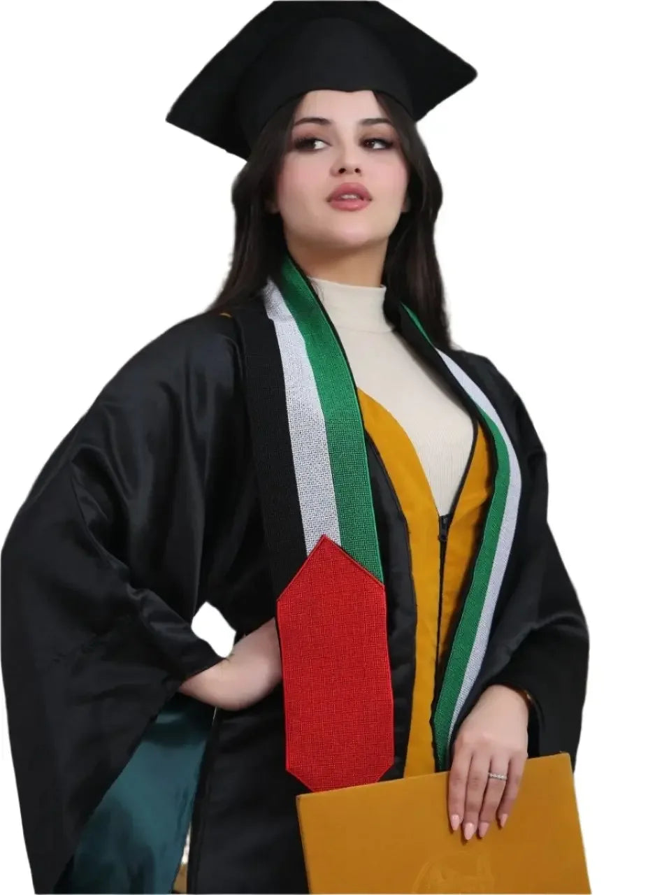 Graduate wearing a tatreez stole with Palestinian flag by Palestinian Elegance over black gown holding diploma