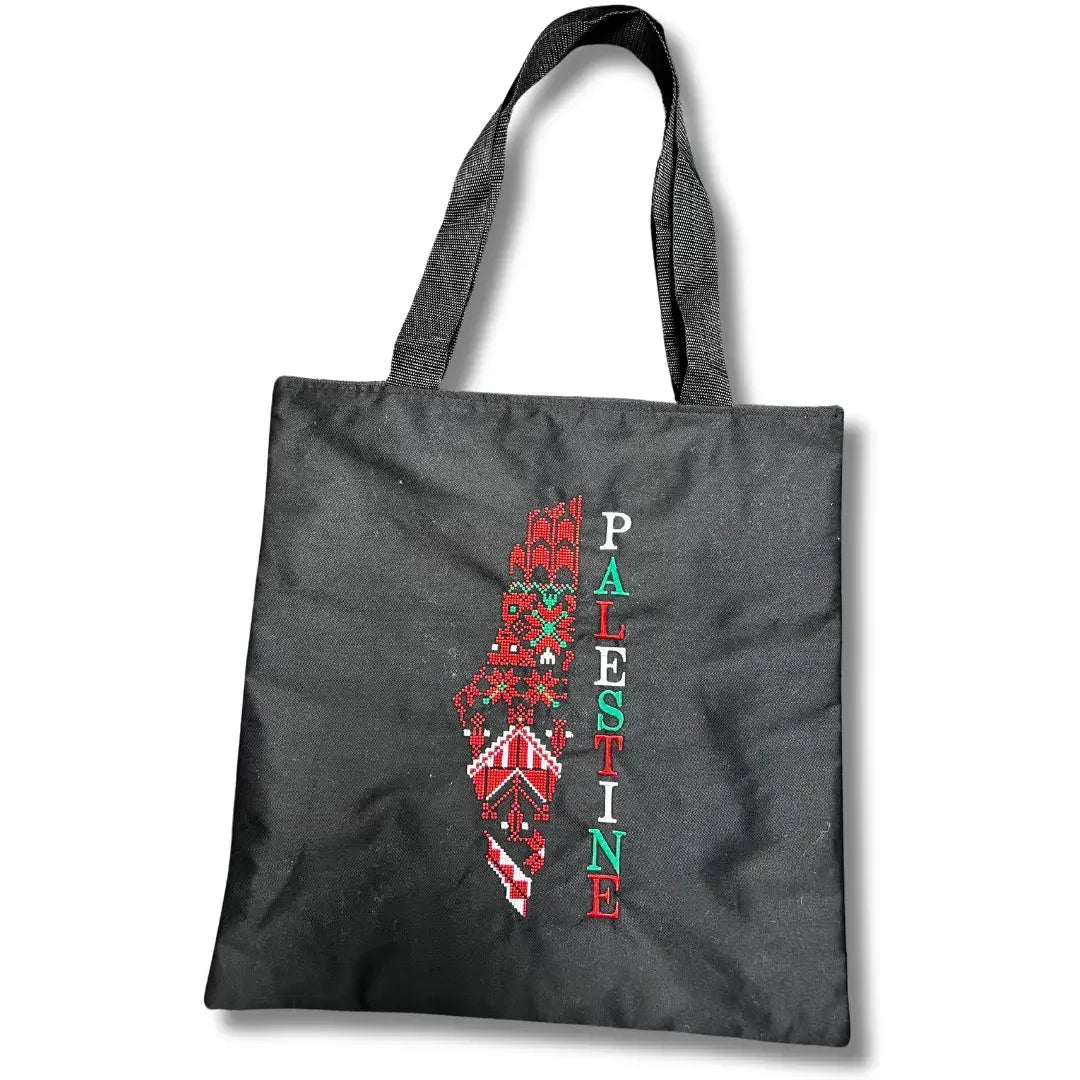 Black tatreez tote bag with embroidered map of Palestine and colorful text from Palestinian Elegance