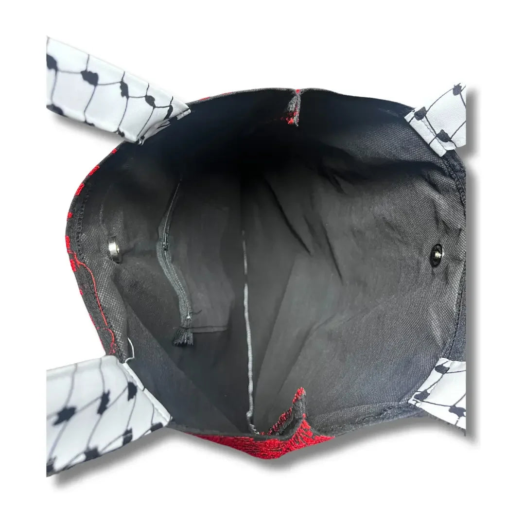 Interior view of Palestinian Elegance tatreez tote bag showing black lining and patterned handles