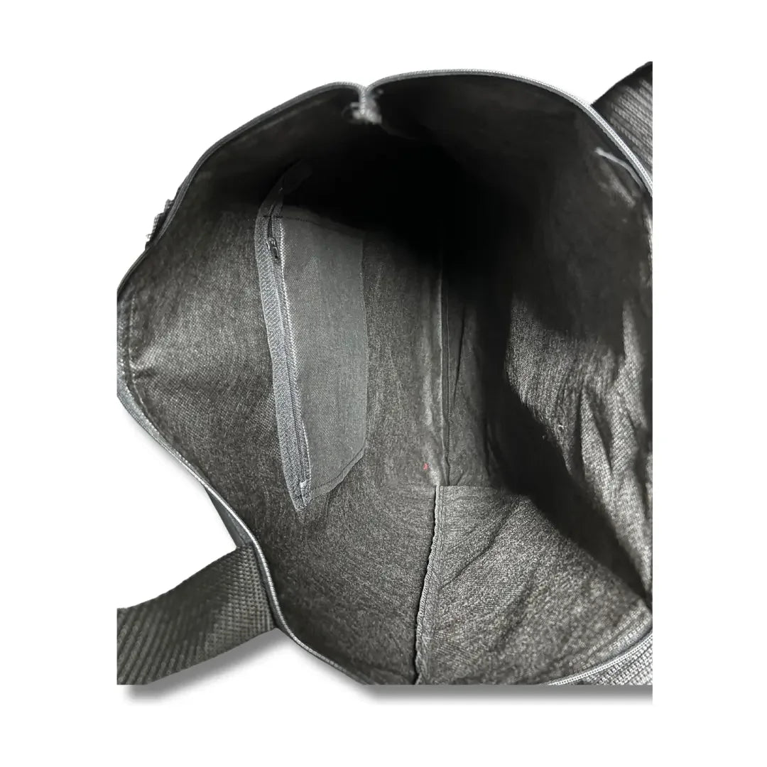 Interior view of black Palestinian Elegance tatreez tote bag showing spacious lining and inner pocket