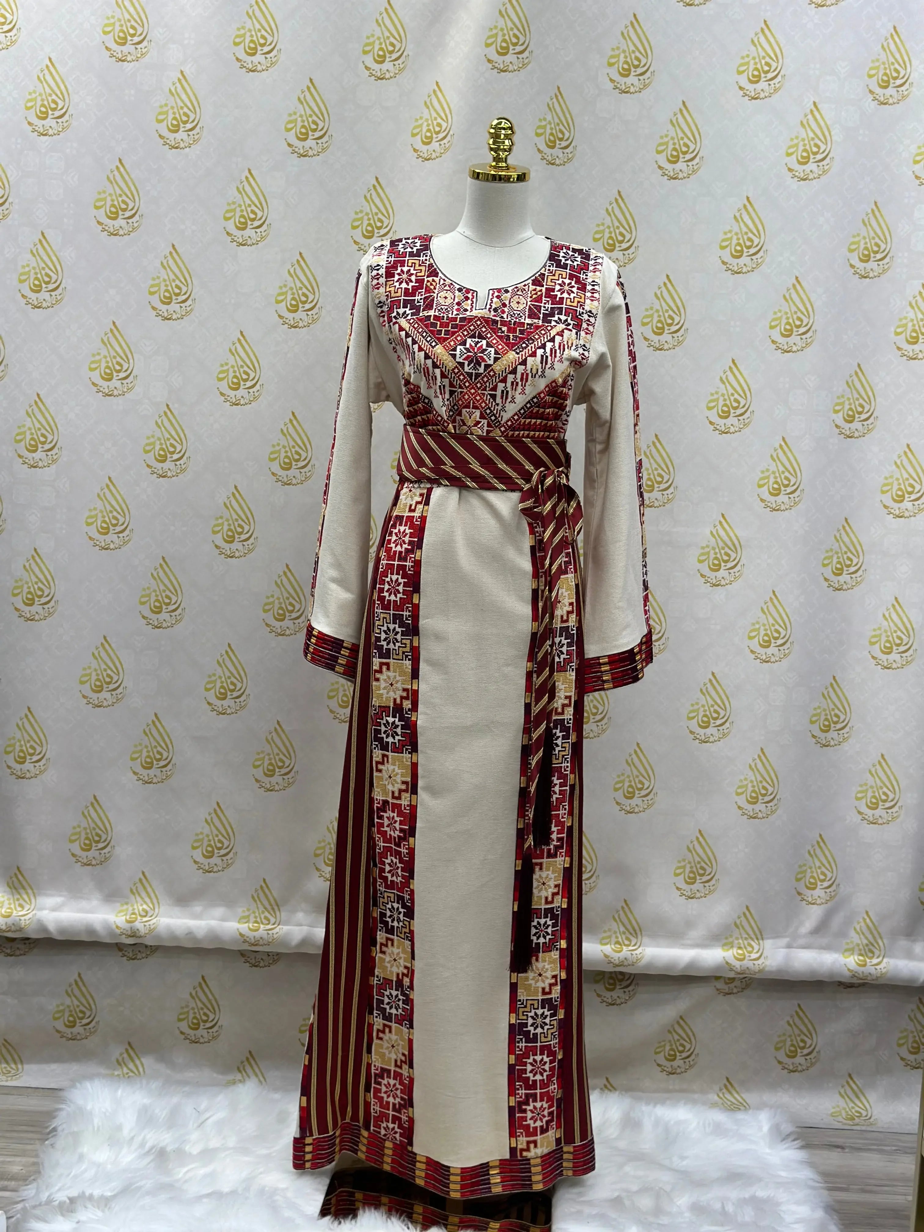Traditional Atameen thoub kashmir embroidered dress by Palestinian Elegance with intricate red and cream embroidery
