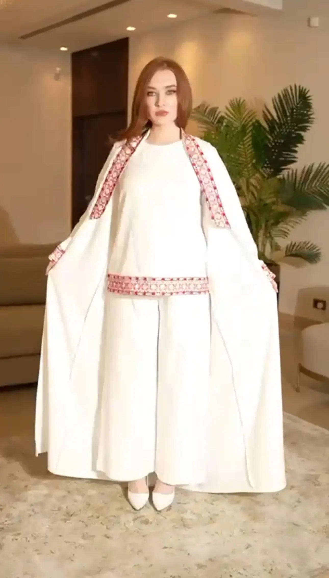 Palestinian Elegance white traditional embroidery suit with red intricate patterns and flowing cape