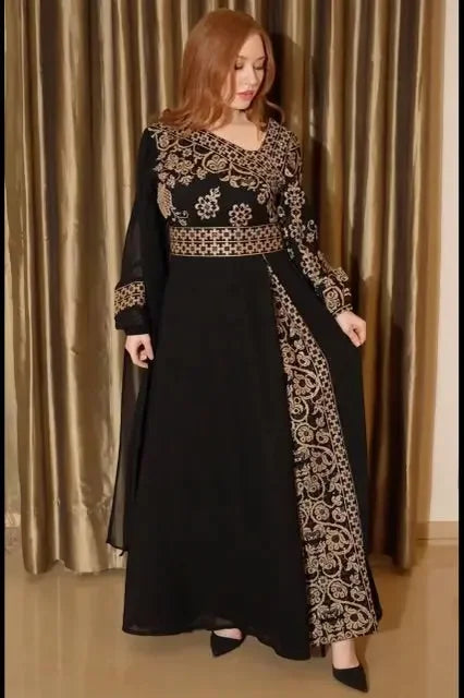 Black traditional Palestinian embroidery dress with intricate gold detailing on sleeves and front panel